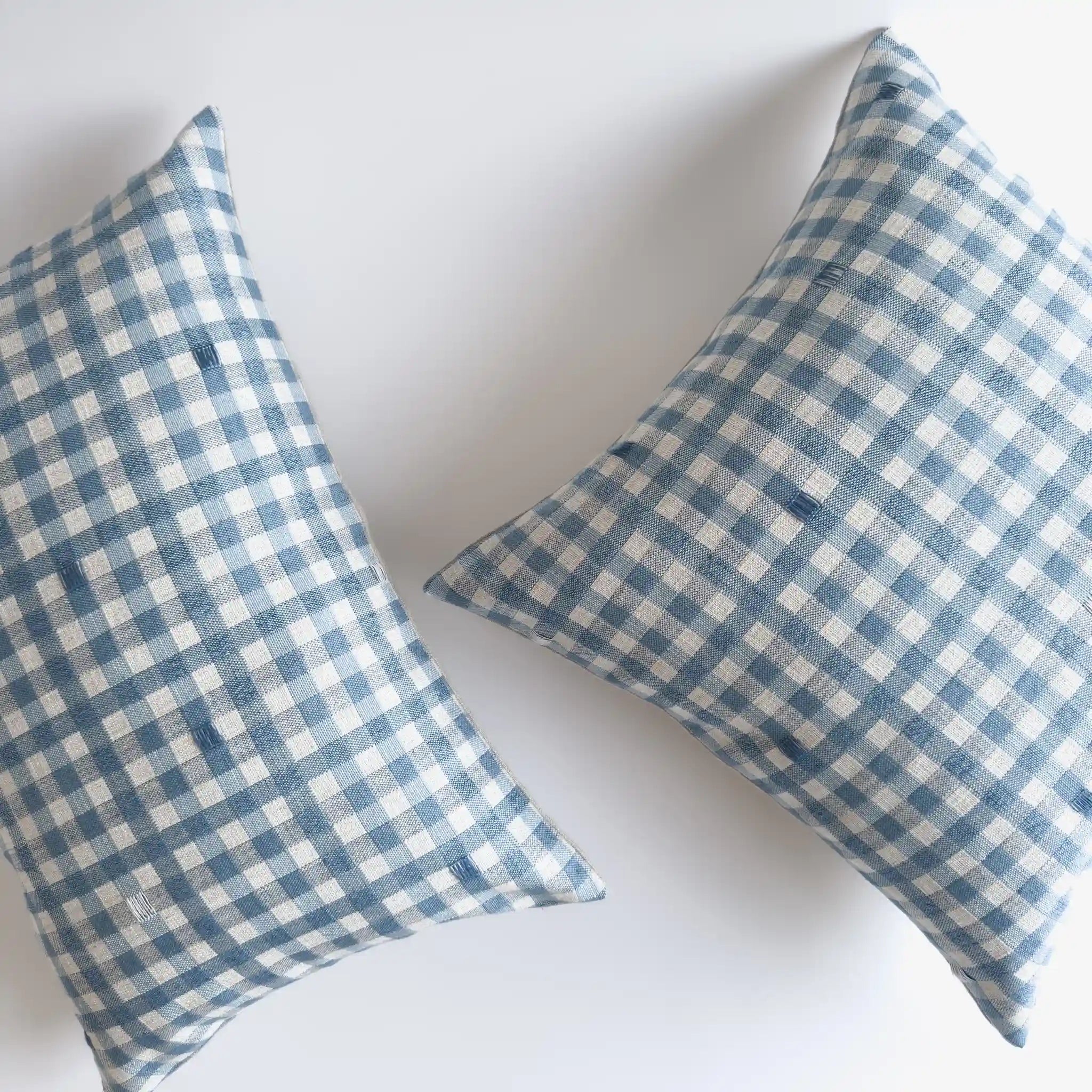 Light blue checkered cushions in square and lumbar styles