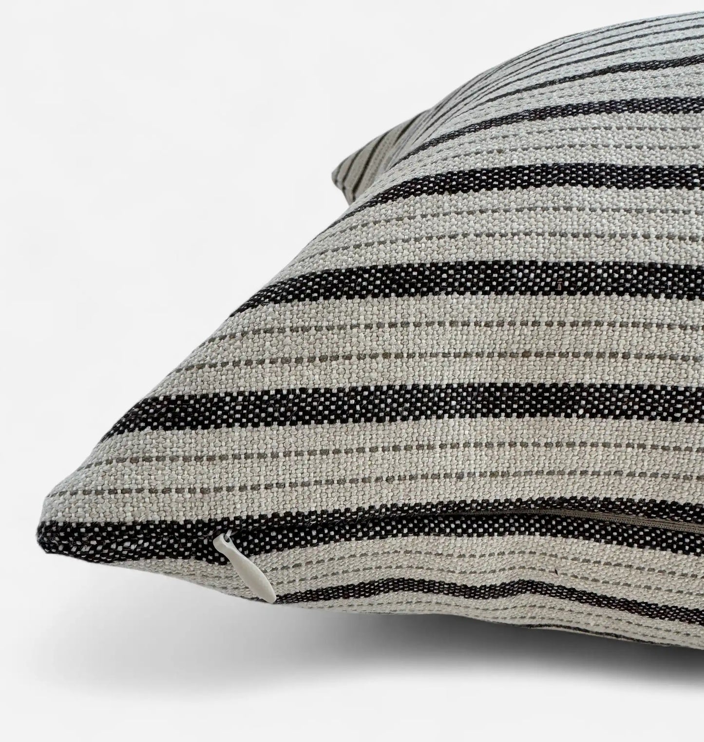 Detail view of black and white striped cushion cover with concealed zipper