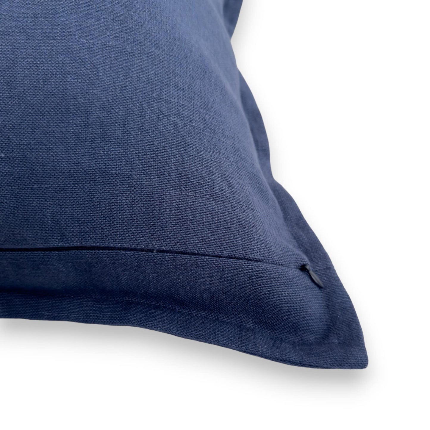 Detail view of navy linen cushion cover with concealed zipper