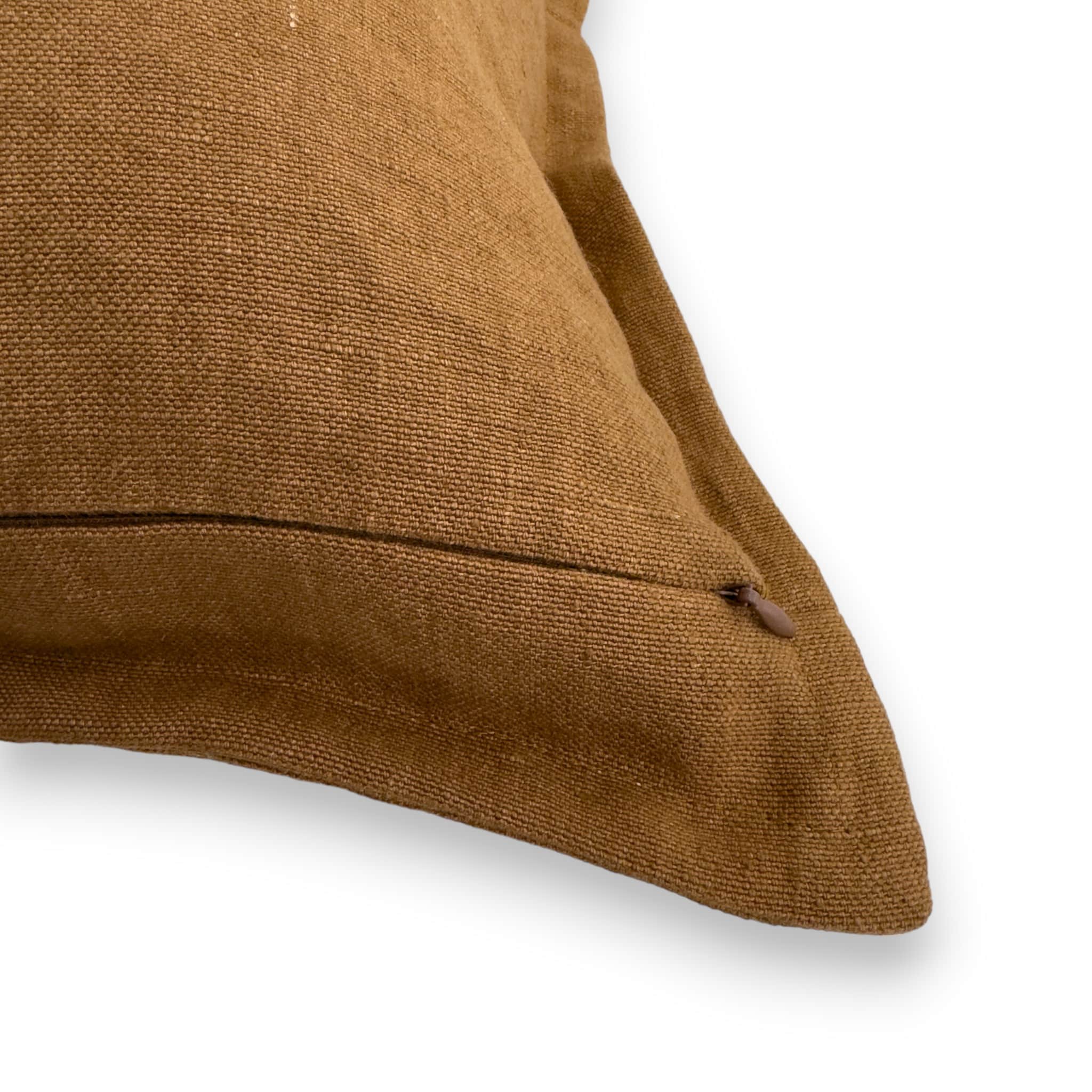 Detail view of tan brown linen cushion cover with concealed zipper