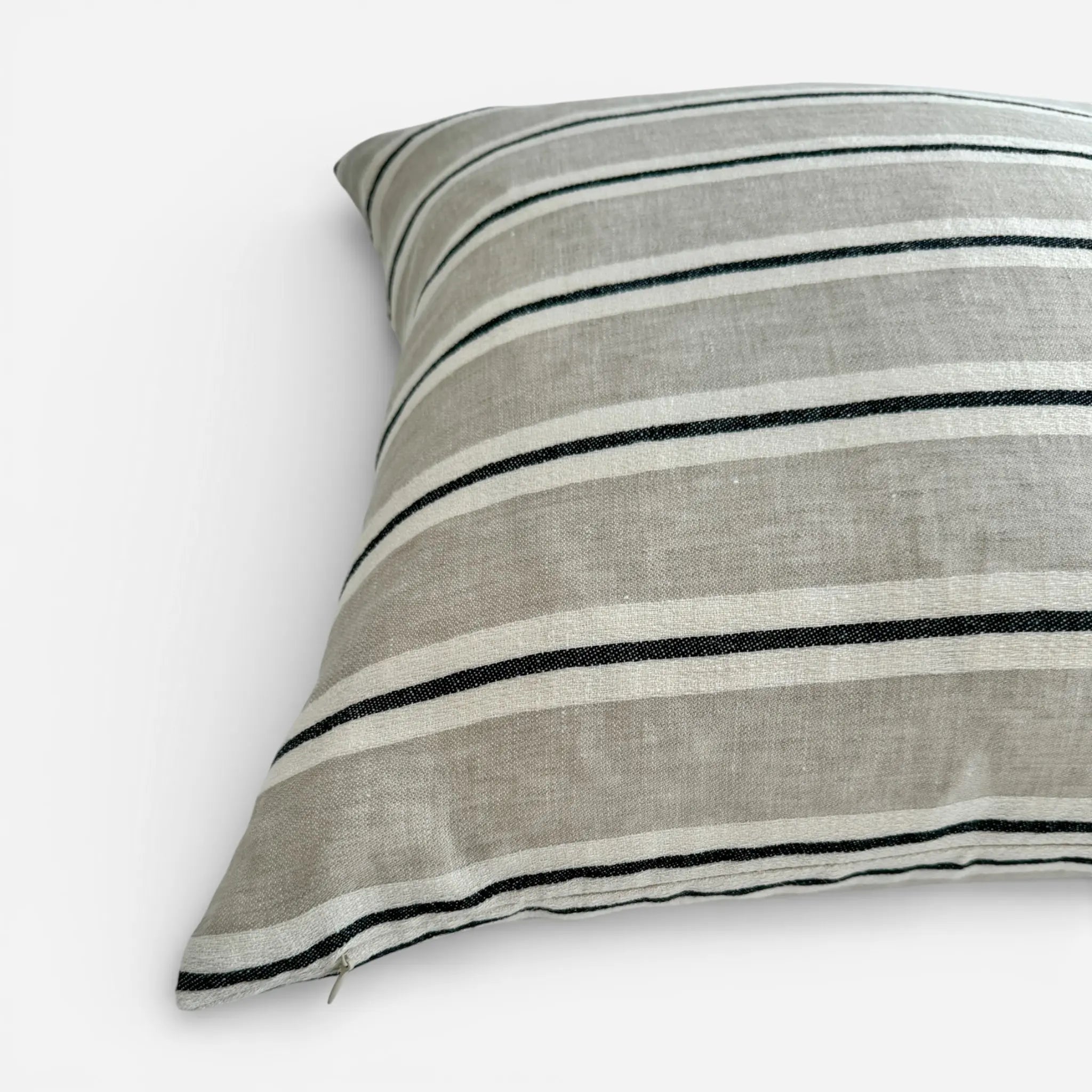 Detail view of black and white striped linen cushion cover