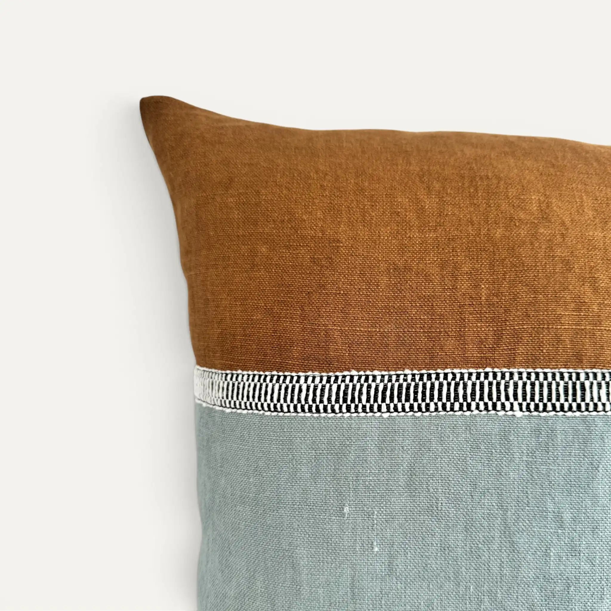 Duck egg blue and brown stonewashed linen cushion cover with black and white decorative ribbon detail