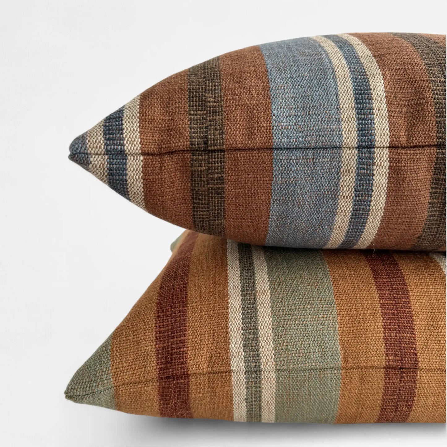 Two colourful striped cushions stacked on top of each other