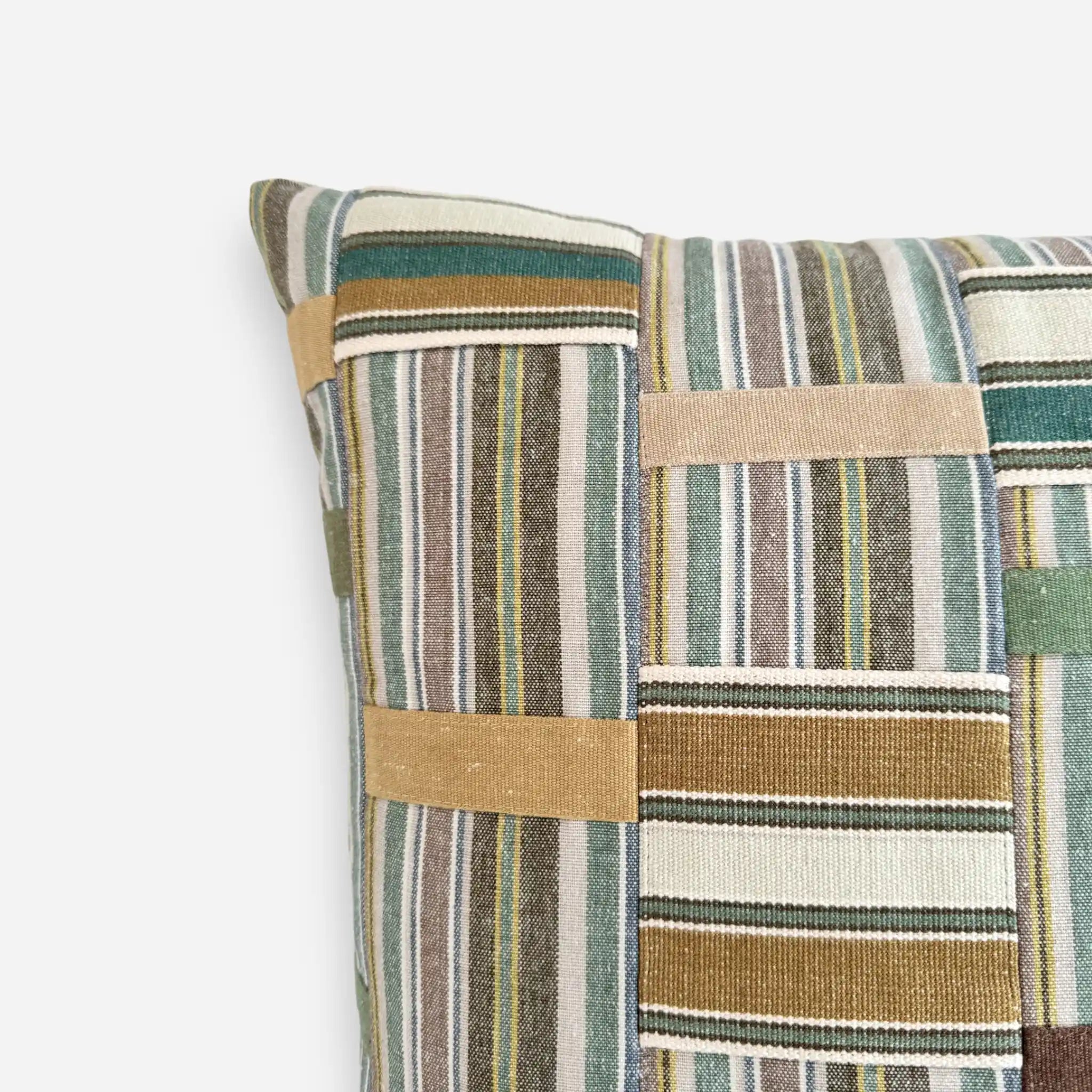 Detail view of colourful patchwork cushion cover inspired by Ewe Kente Cloth textiles
