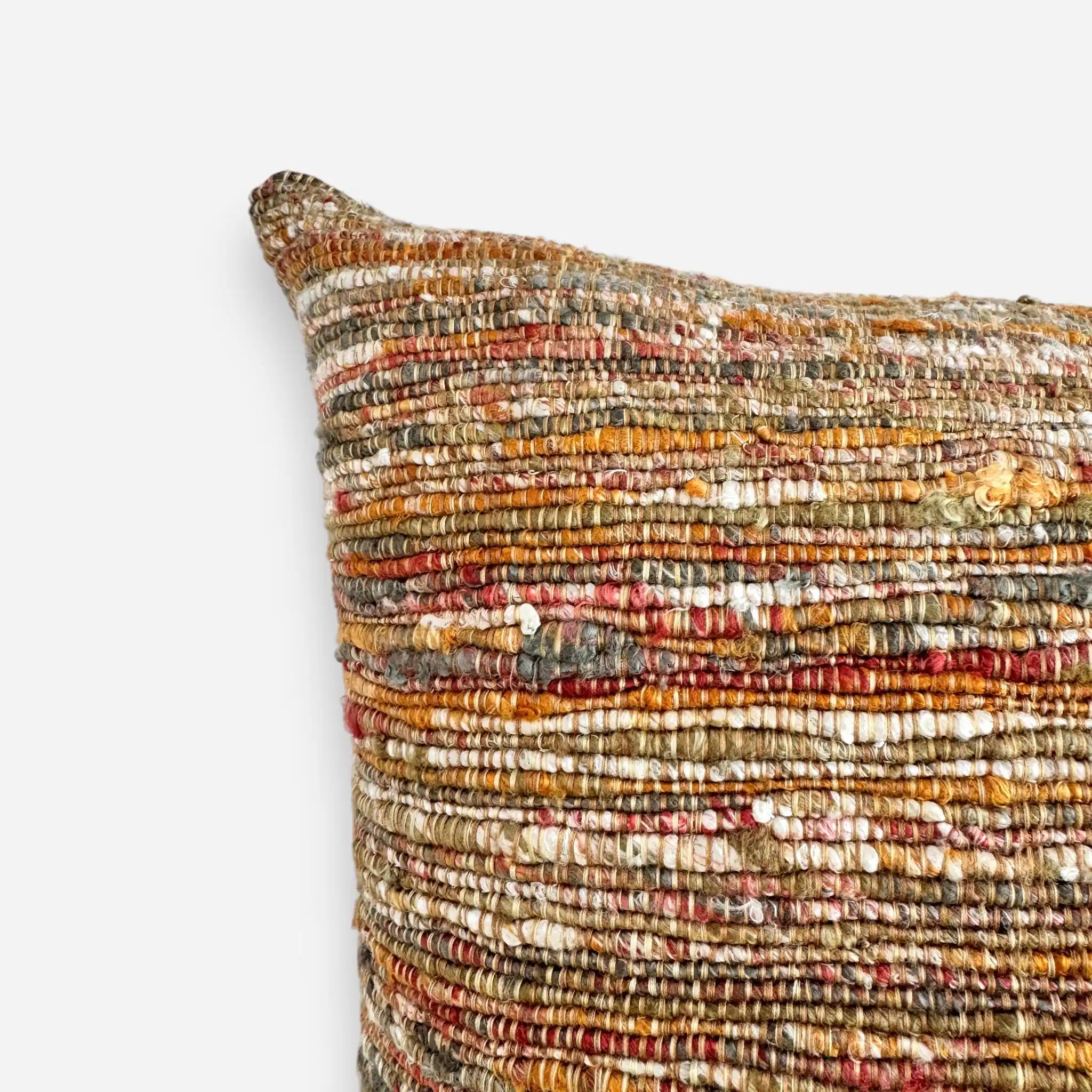 Detail view of handwoven texture of a luxury orange and green cushion cover