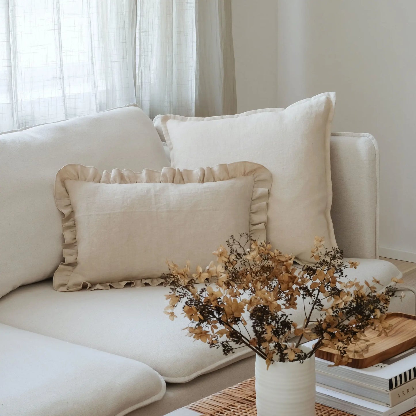 Neutral white and cream linen cushions on a white sofa
