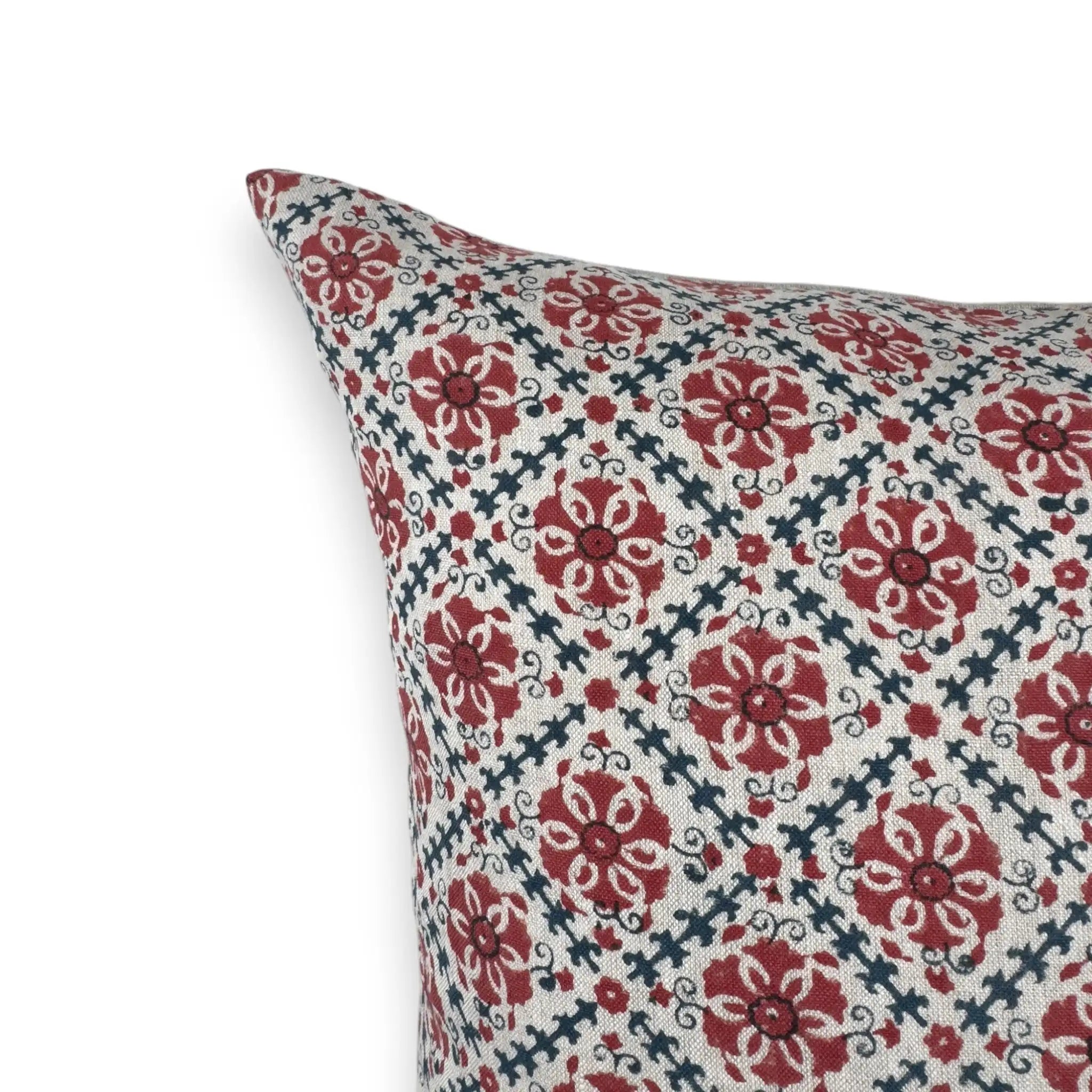 Detail view of a red and blue block printed floral linen cushion cover
