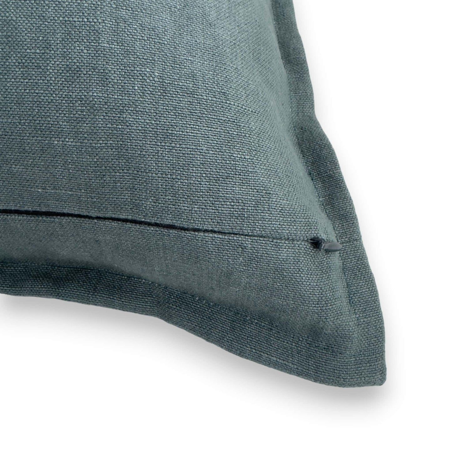 Detail view of teal linen cushion cover with concealed zipper