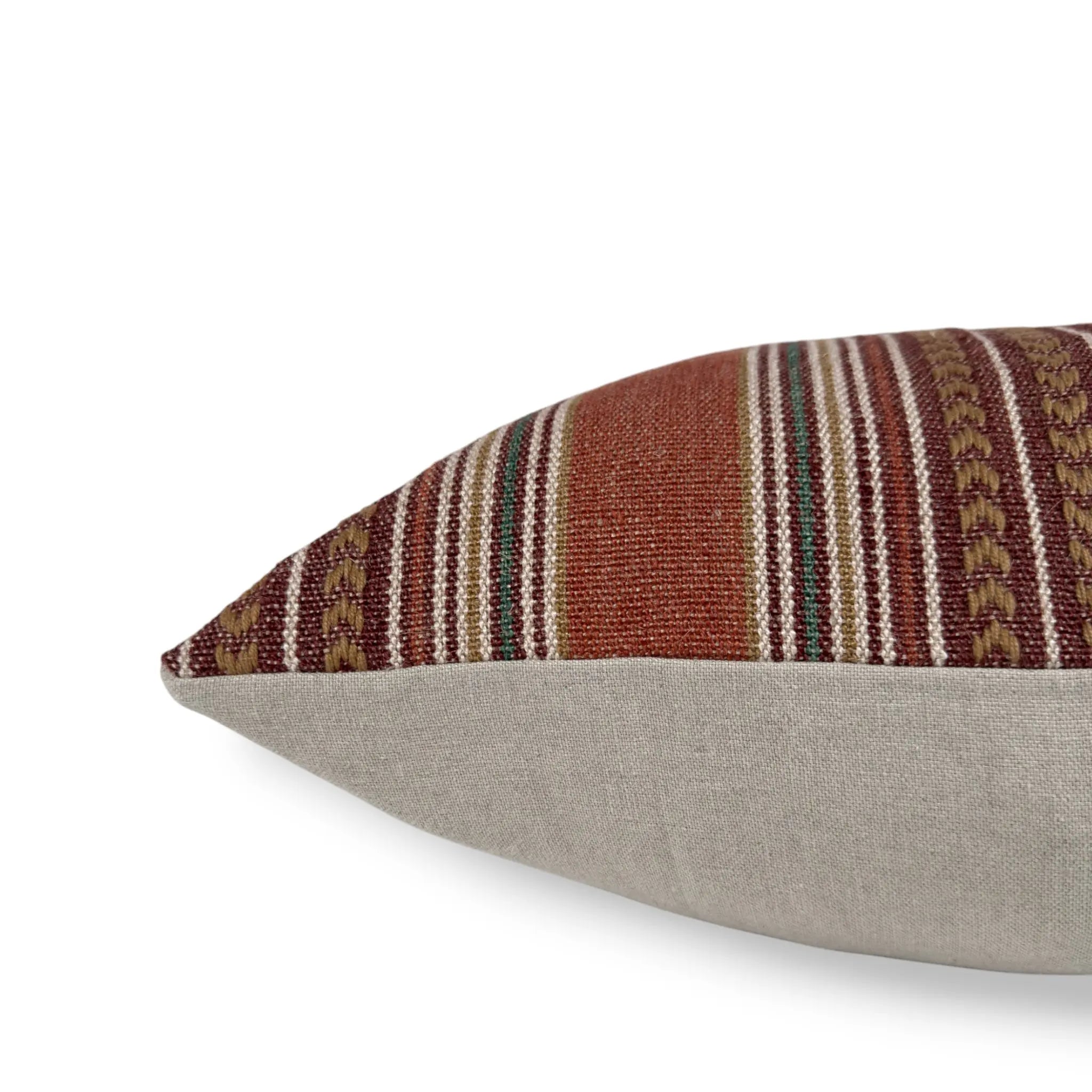 Side view of a bohemian red striped cotton and jute cushion cover