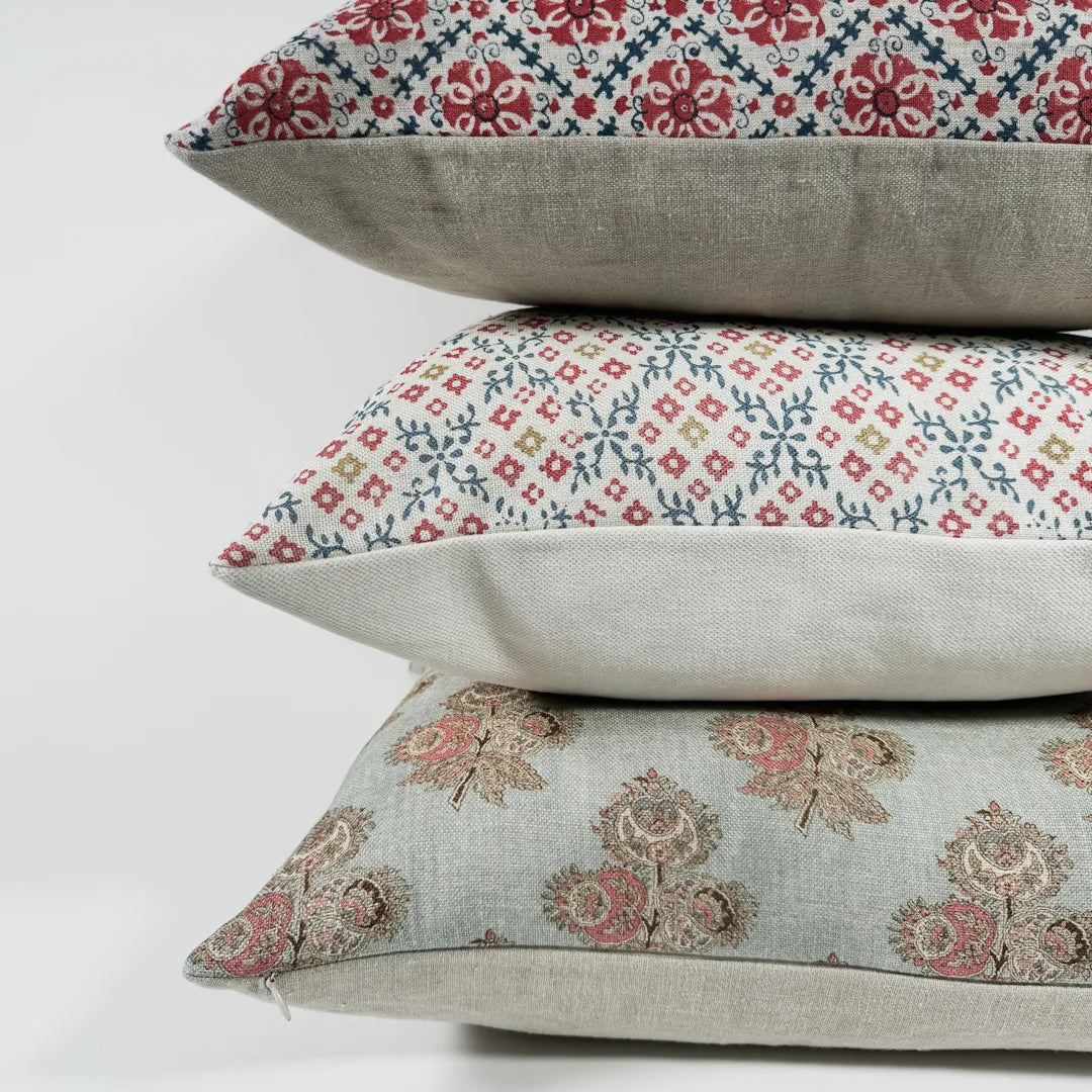 Floral and block printed cushions stacked on top of each other