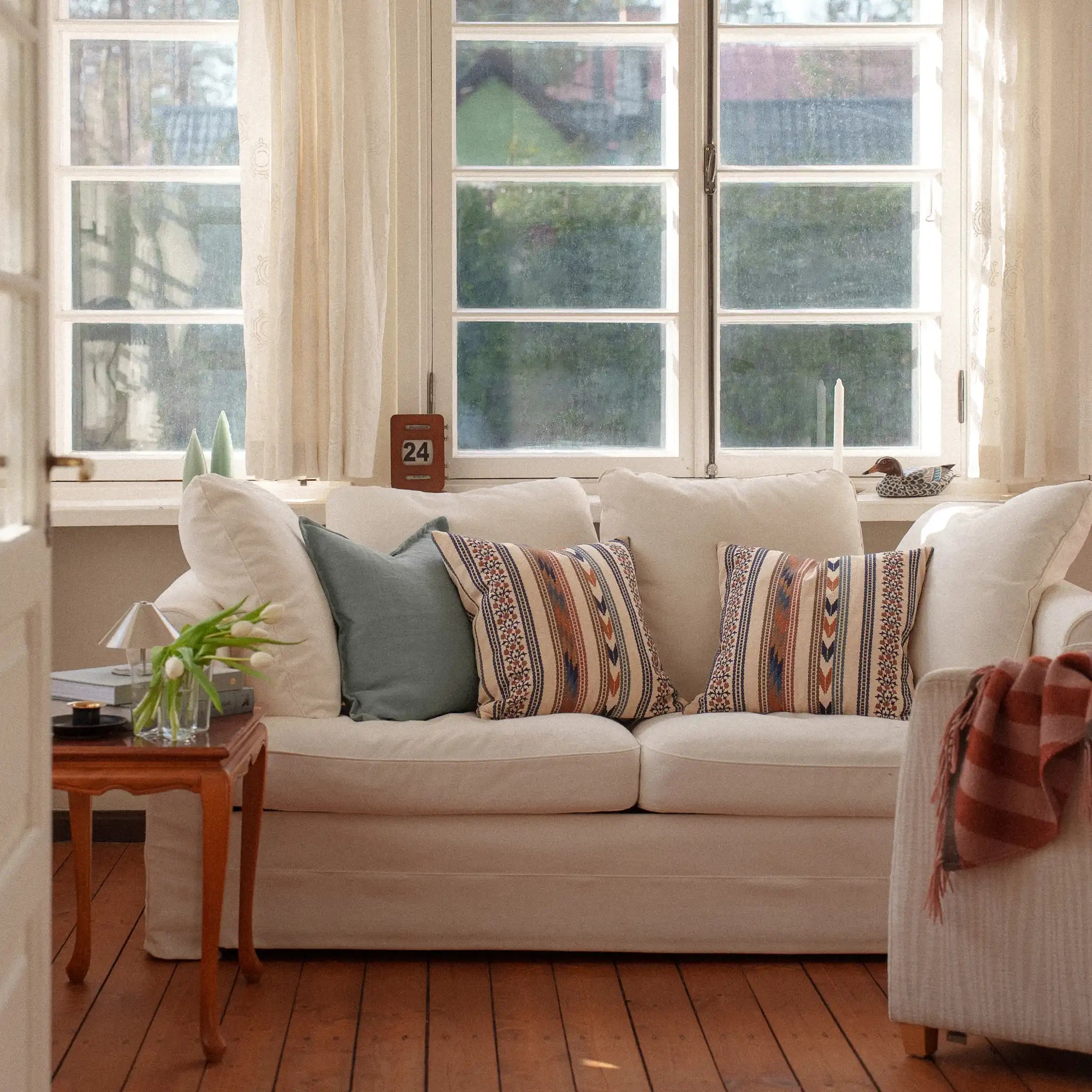 Morris & Co Bloomsbury Stripe cushions on a white sofa