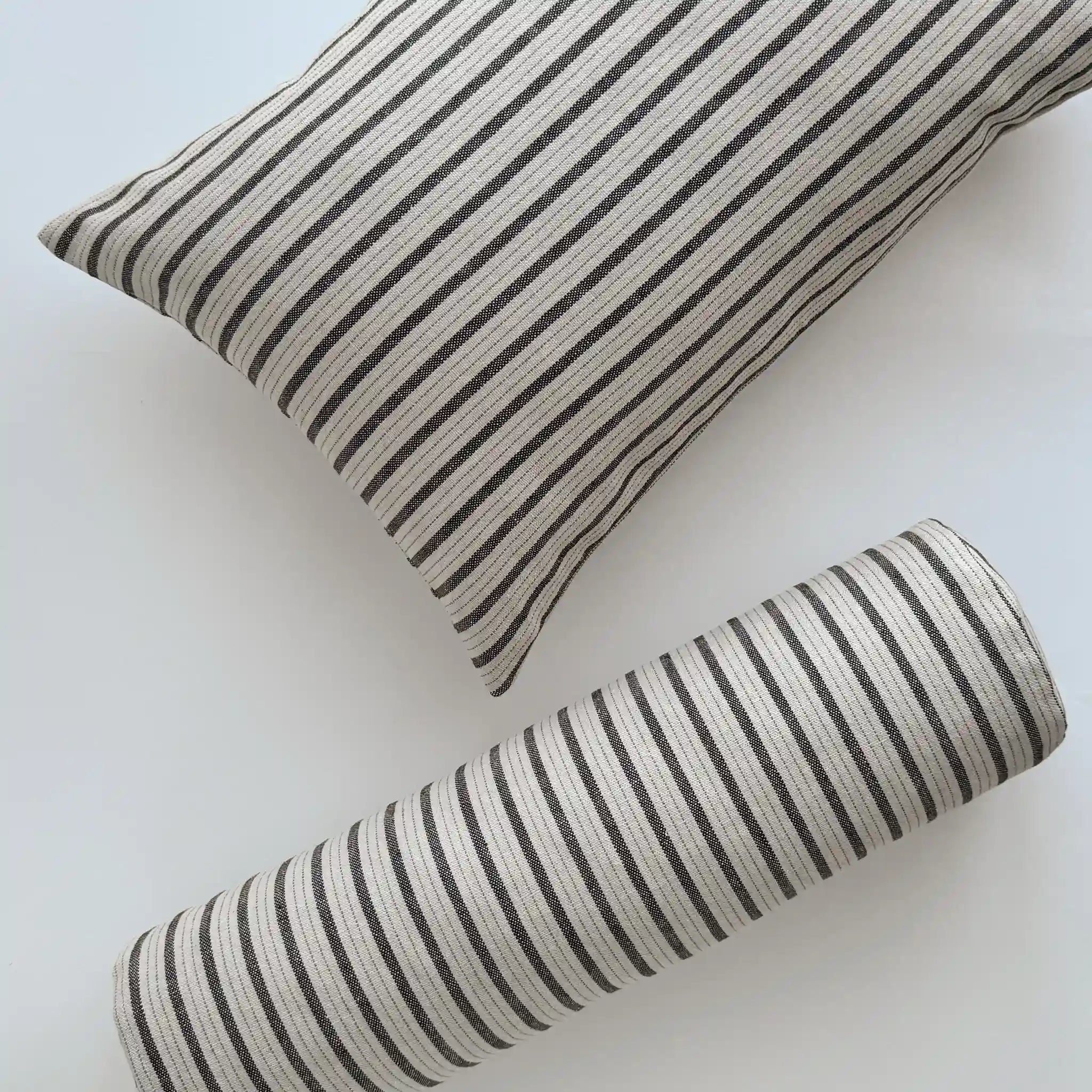 Black and white striped linen blend cushions in lumbar and bolster styles