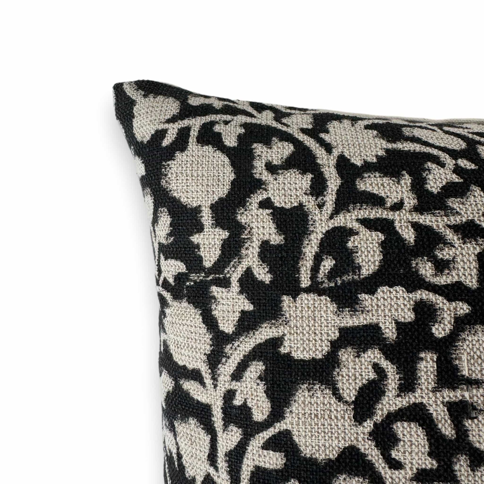 Close up view of a black and white block print cushion cover