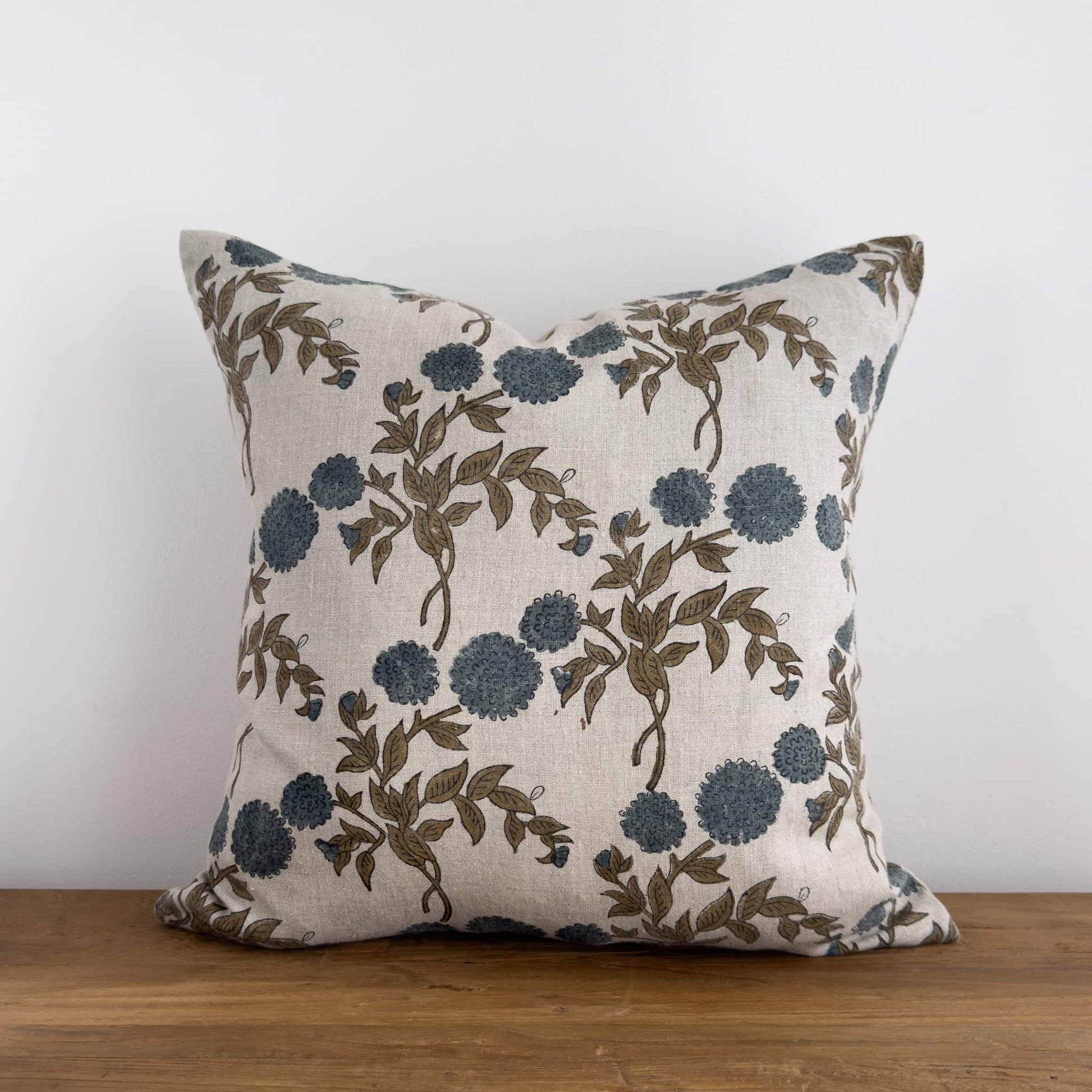 Blue floral block print cushion cover on a bench