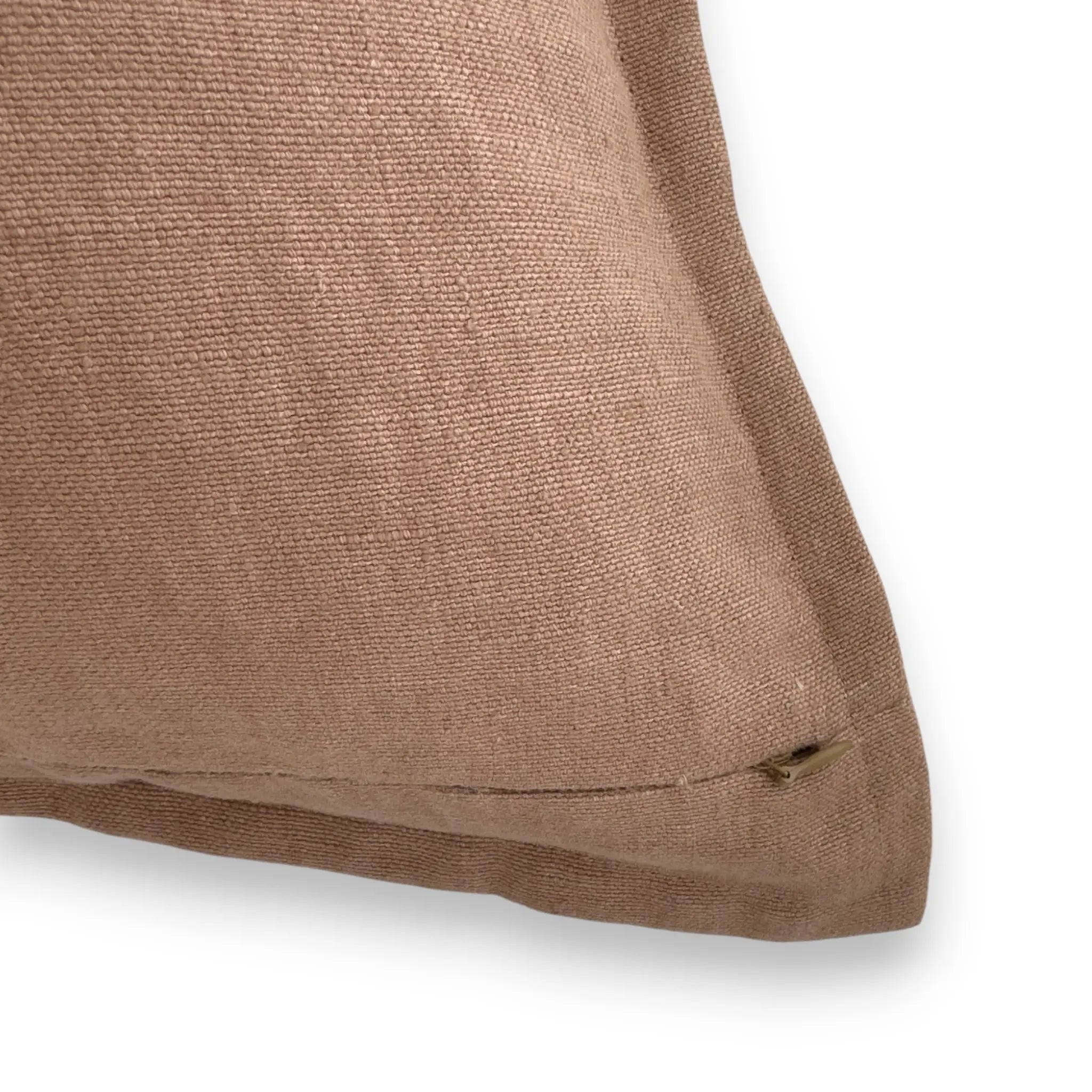Detail view of clay brown linen cushion cover with concealed zipper