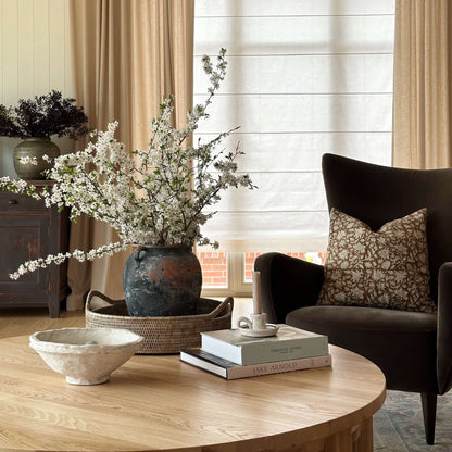 Brown floral block print cushion cover on a chair