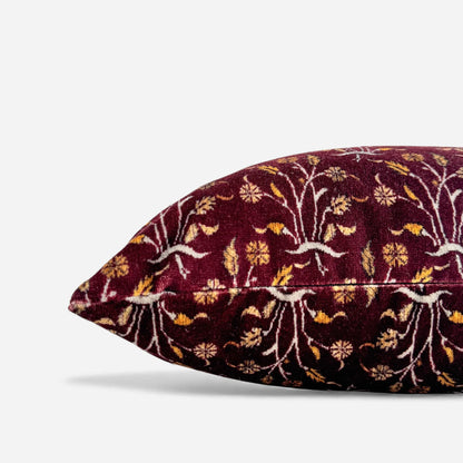 Side view of the burgundy velvet cushion cover with floral pattern