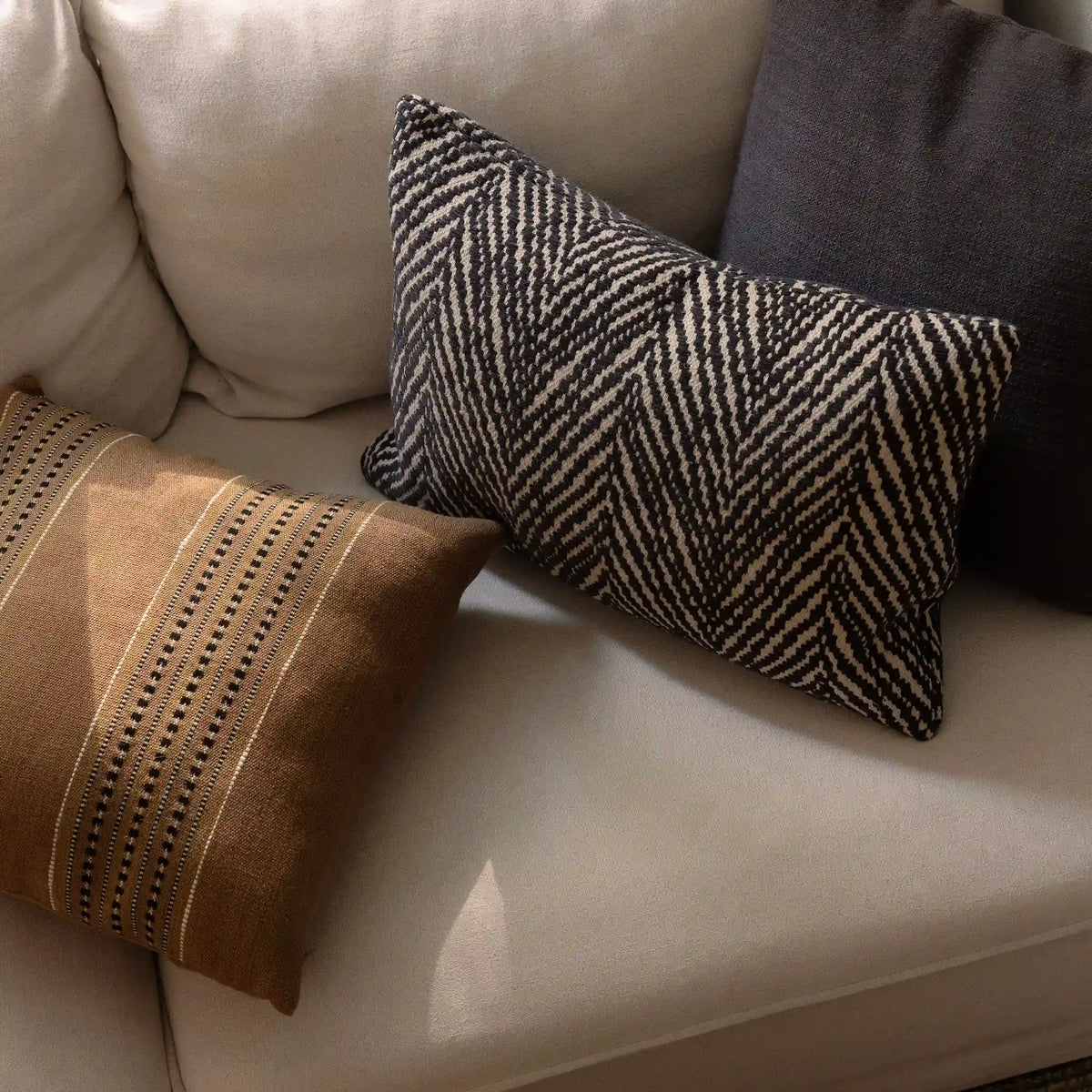 Brown cushion combo in cacao, chocolate and tan hues, with jute, linen and cotton giving it a natural, soft texture.