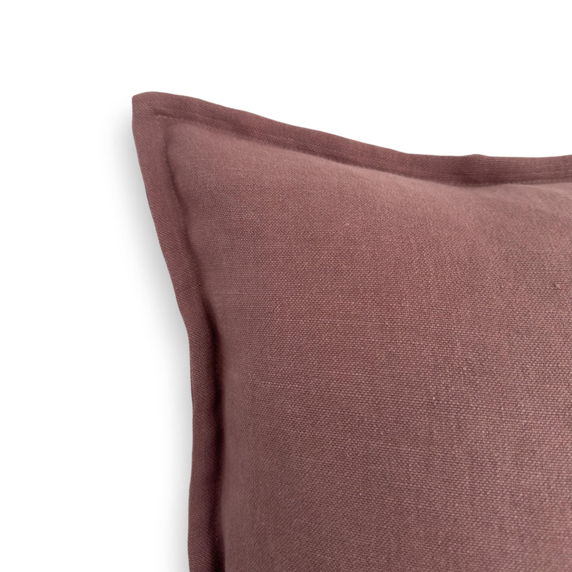 Close up view of a purple linen solid color cushion cover