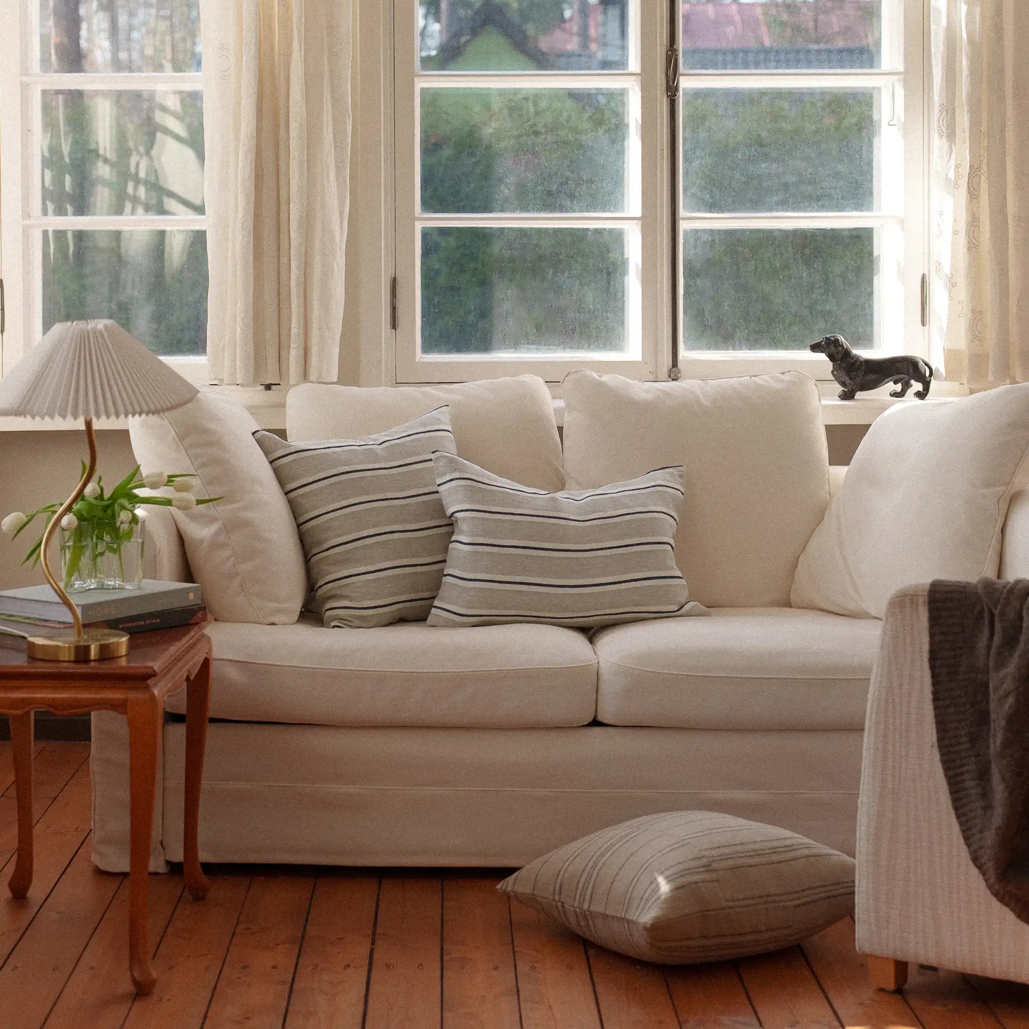 Neutral striped cushions on a white sofa