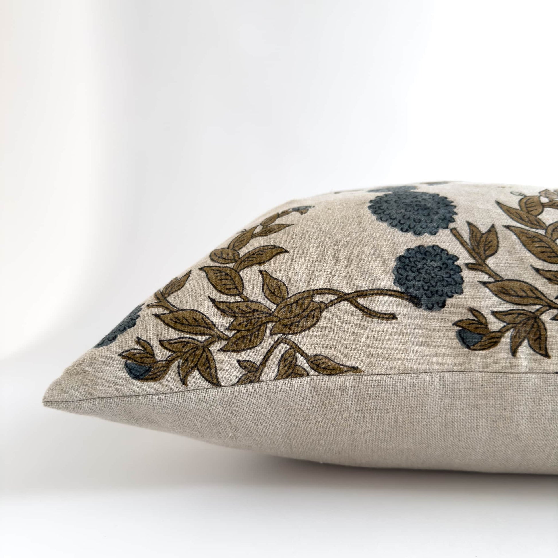 Side view of a blue floral linen block print cushion cover