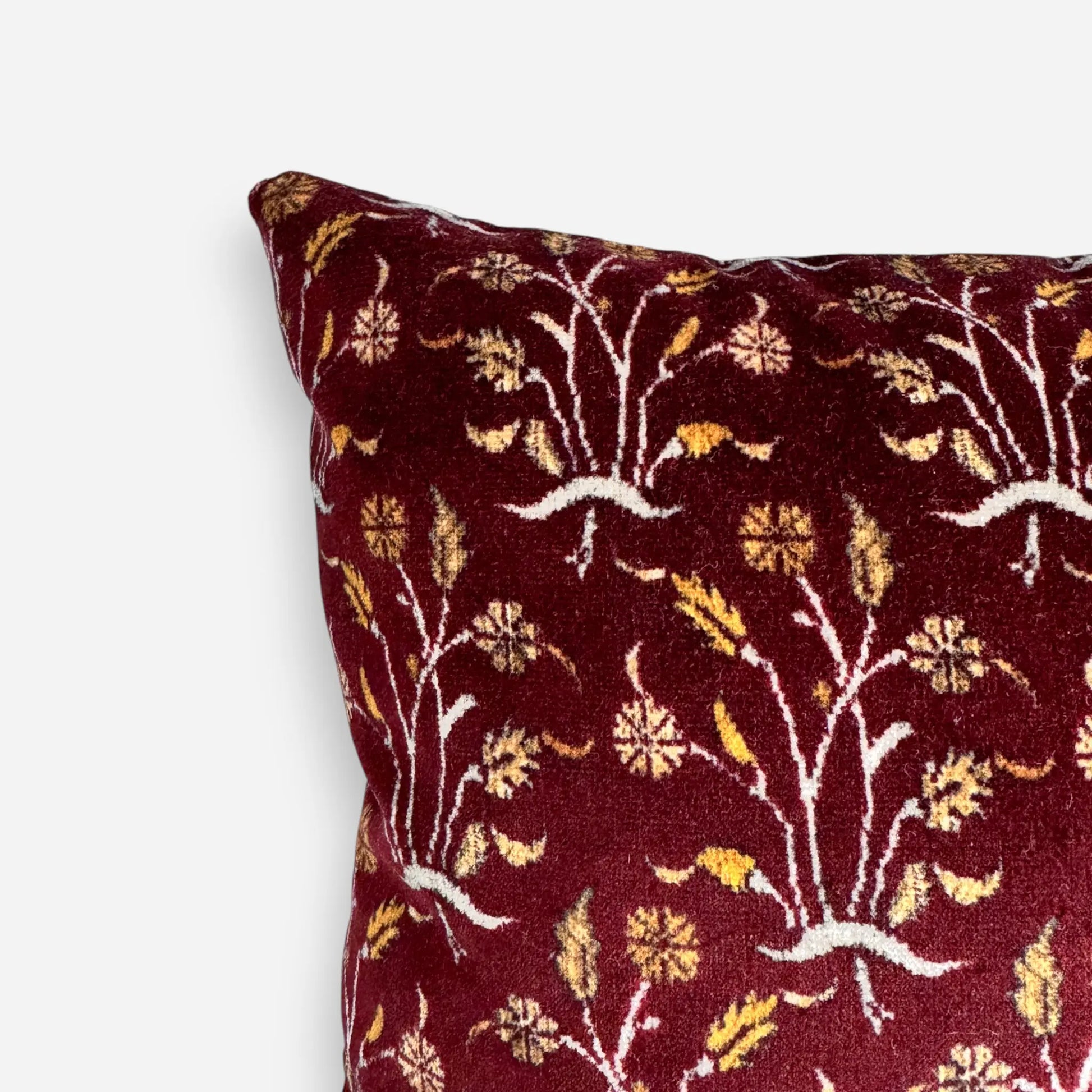 Burgundy velvet cushion cover with ochre floral pattern