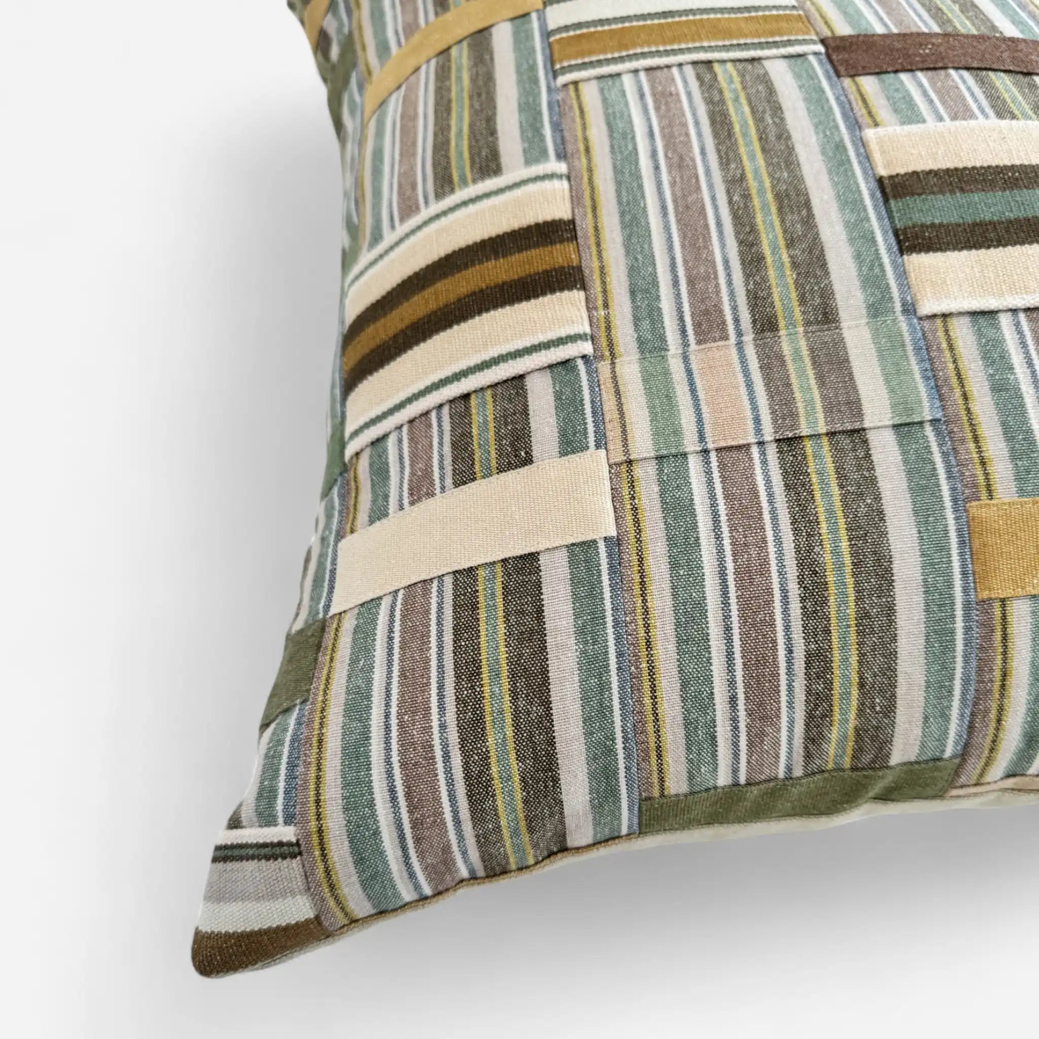 Green patchwork cushion cover inspired by Ewe Kente Cloth textiles