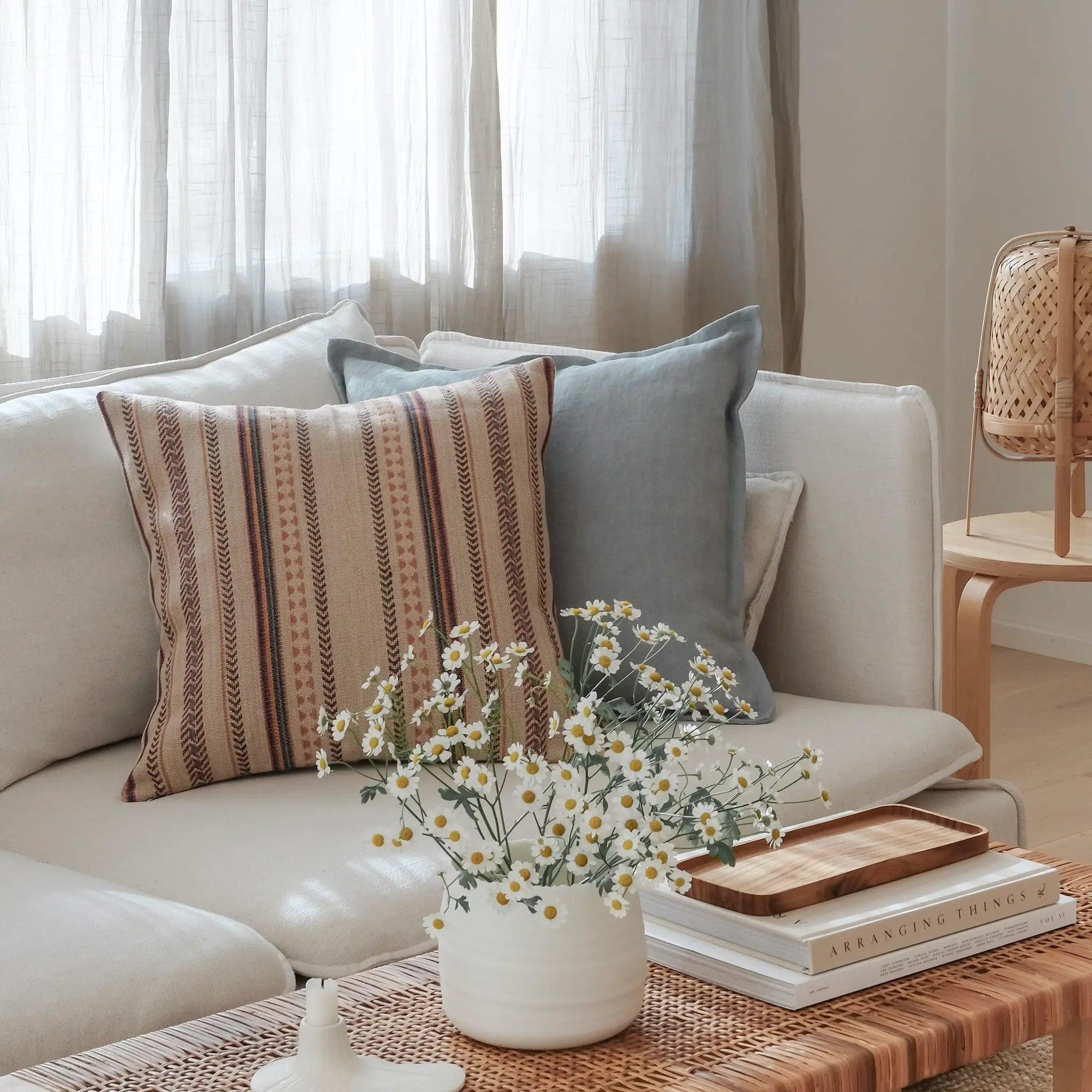 Plain duck egg blue and beige patterned boho cushion styled on white sofa