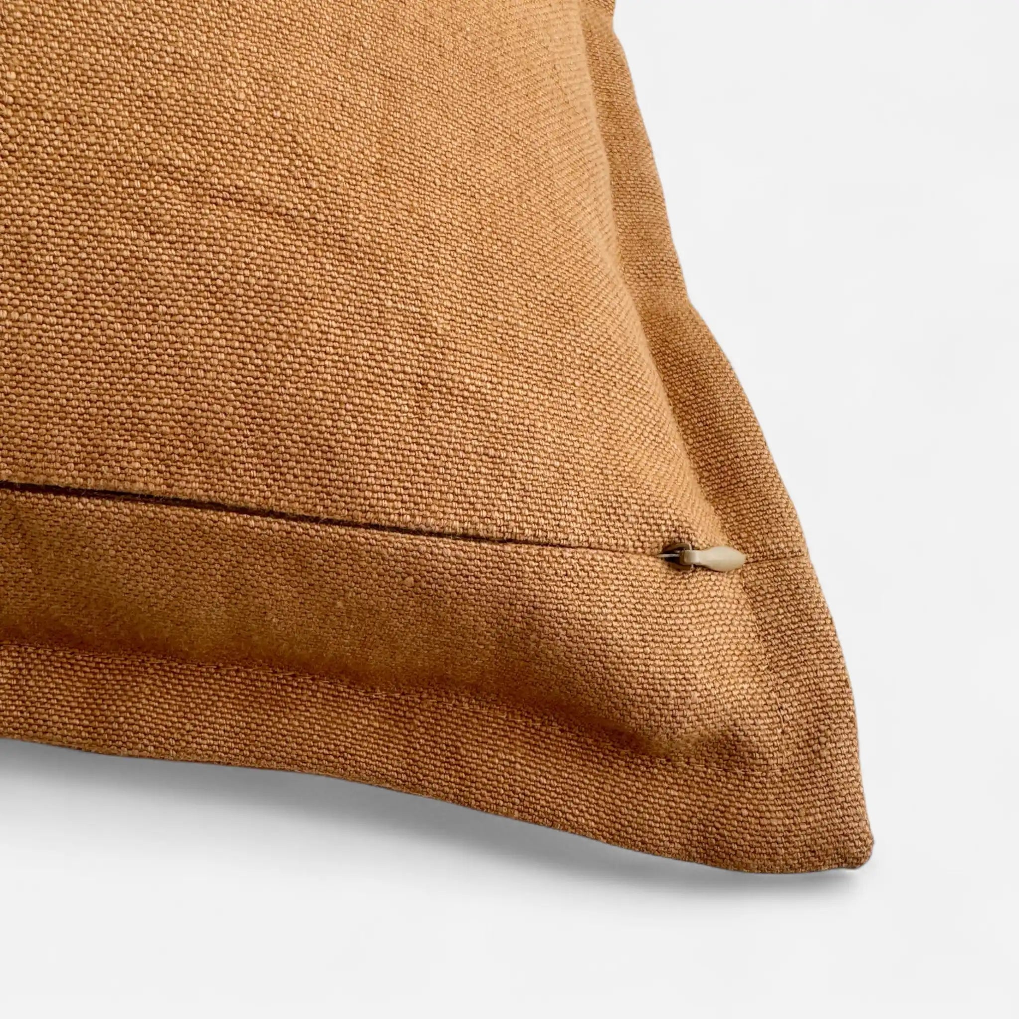 Detail view of caramel brown cushion cover with concealed zipper