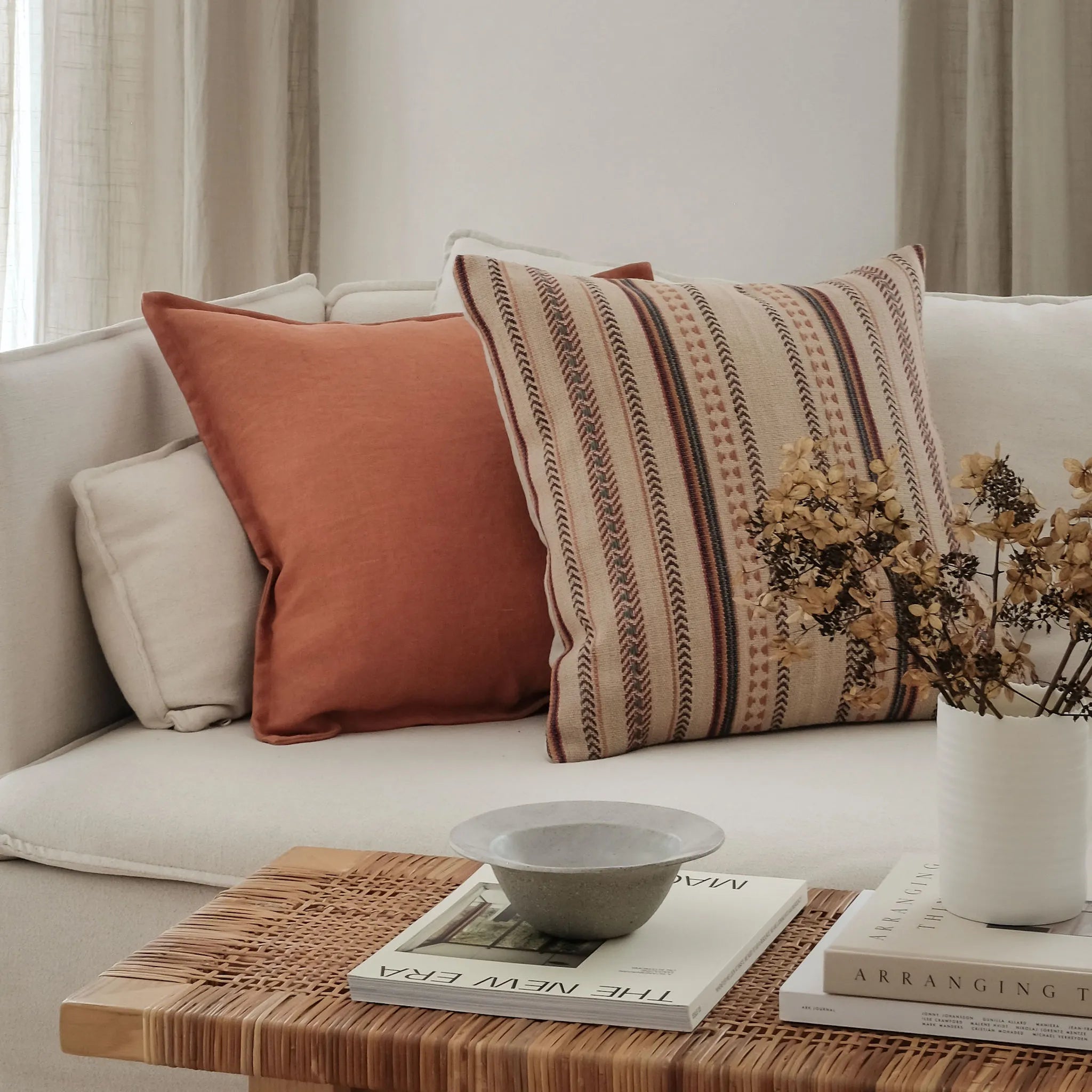Colourful boho inspired cushions styled on a white sofa