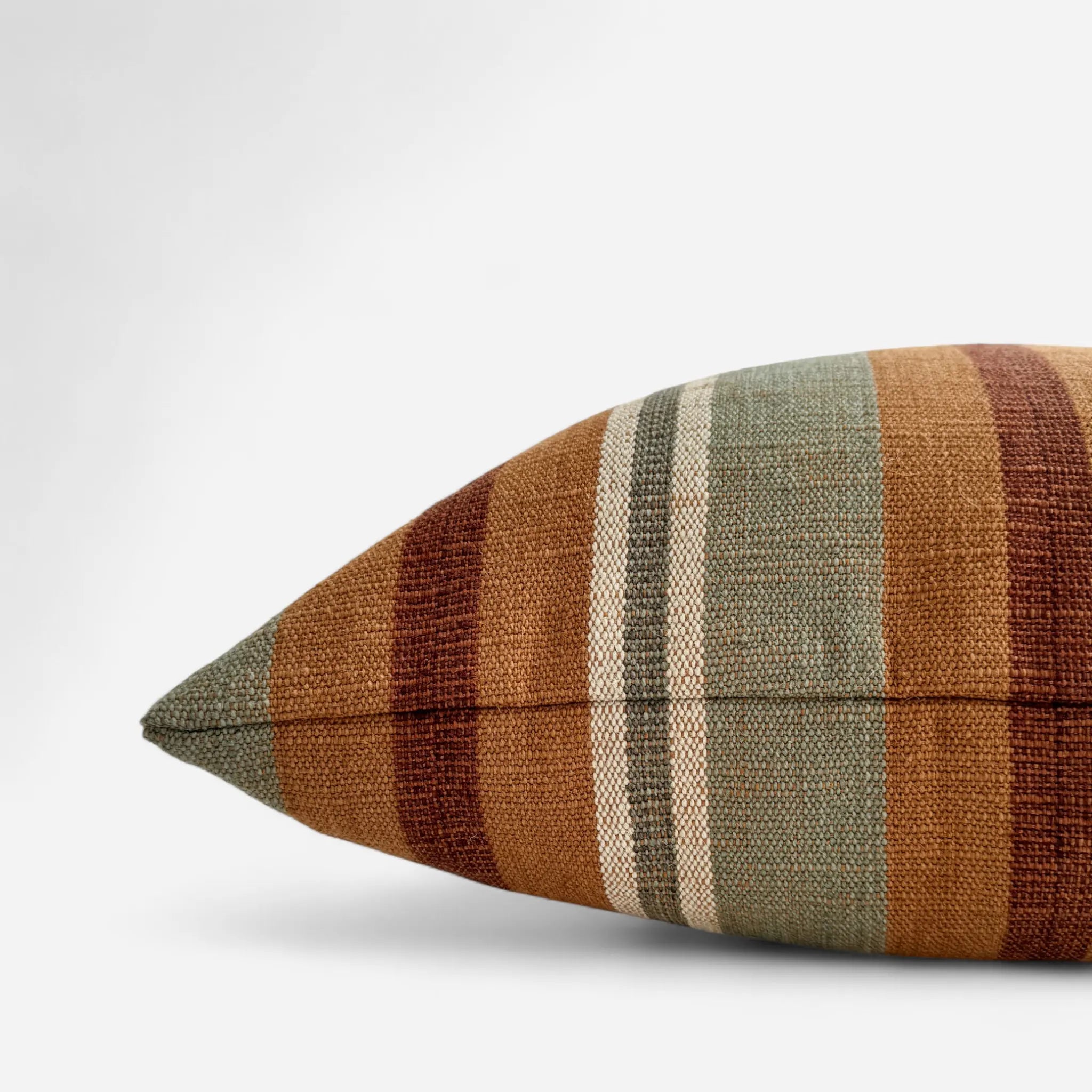 Side view of sage green and sienna natural textured cushion cover