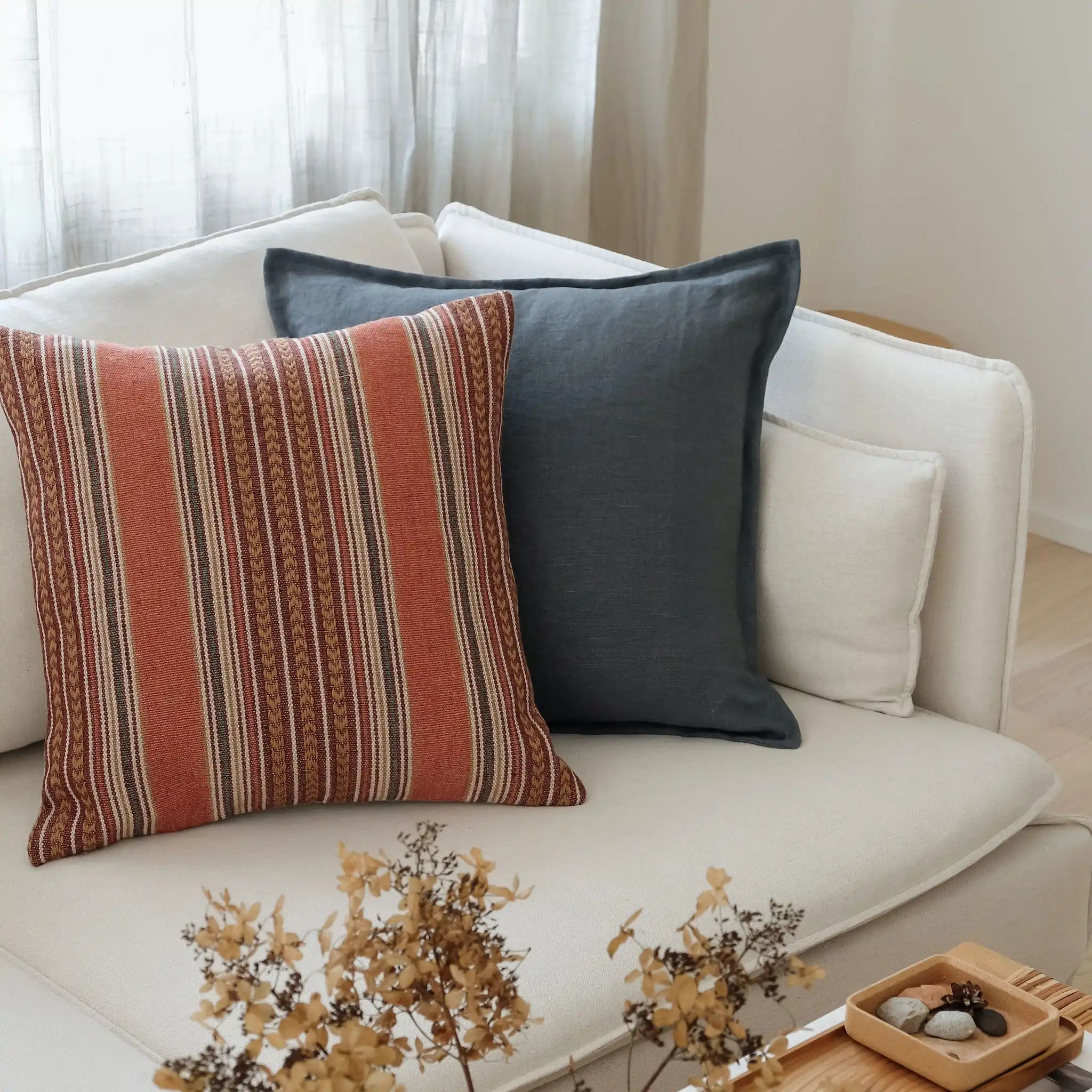 Blue and red natural cushions styled on a white sofa