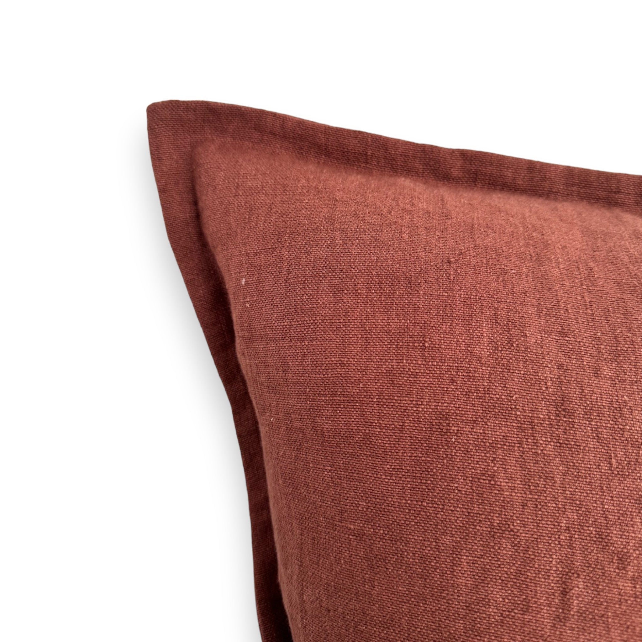 Detail view of a dark red solid colour linen cushion cover