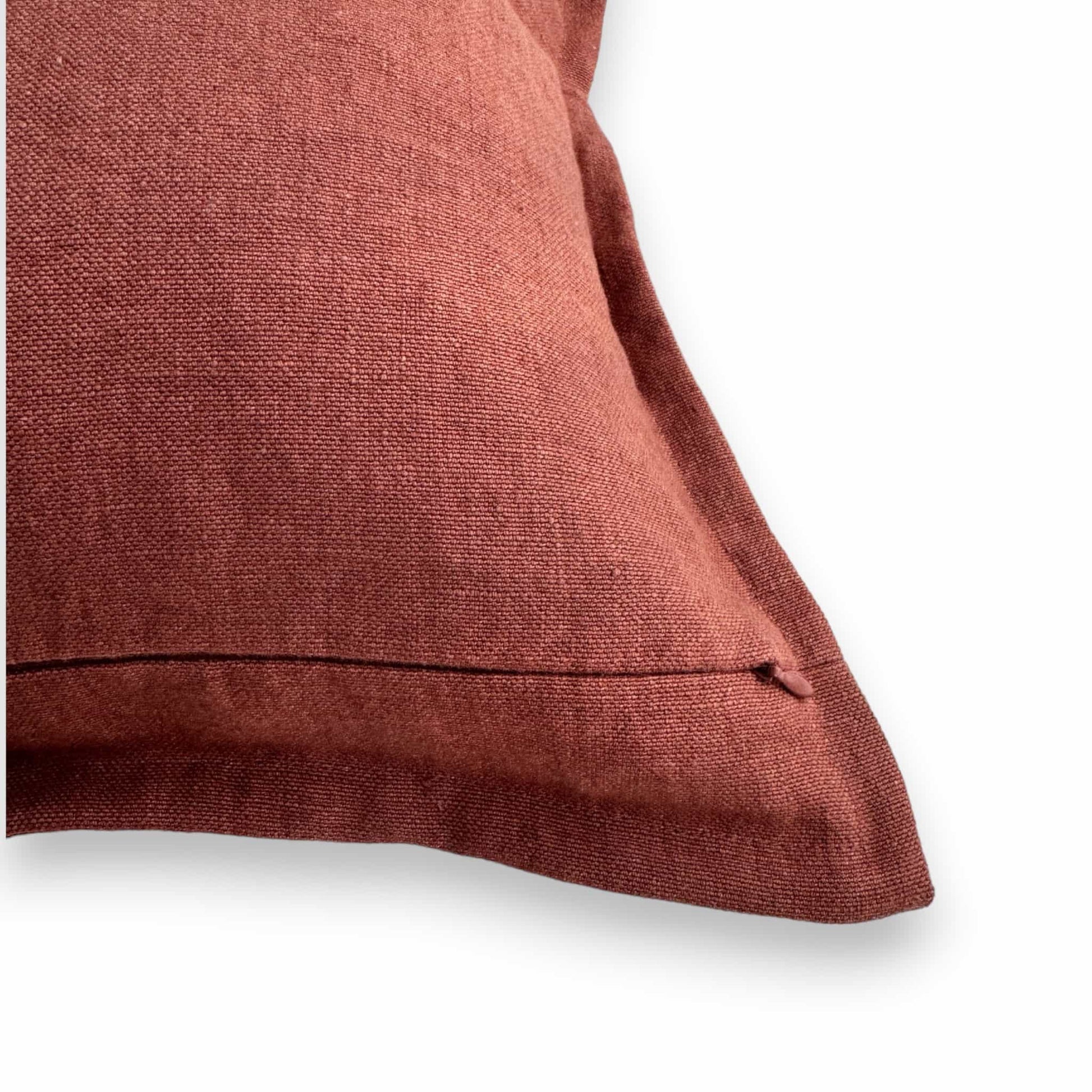 Close up of a zipper of a red solid color linen cushion cover