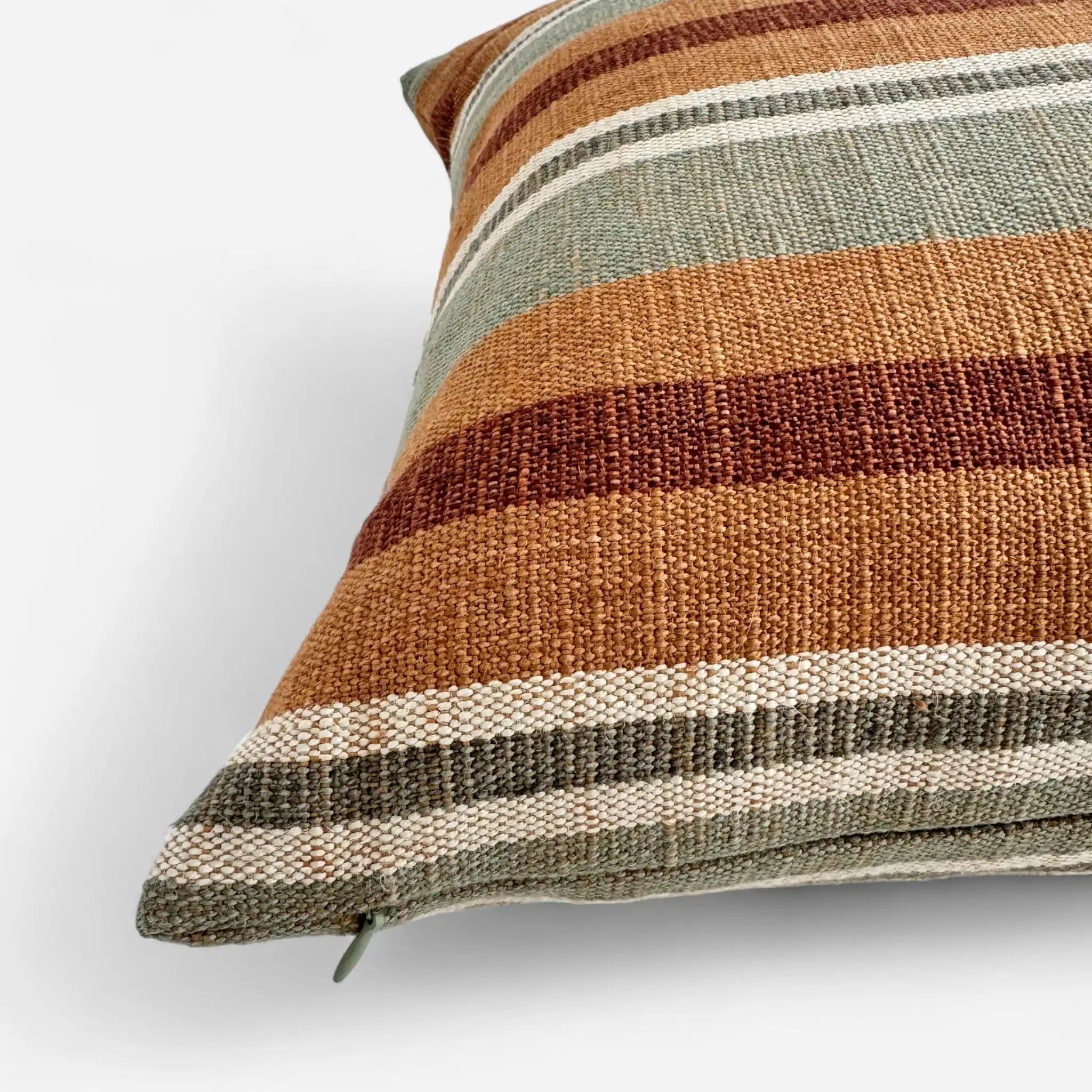 Detail view of sage green and sienna cushion cover