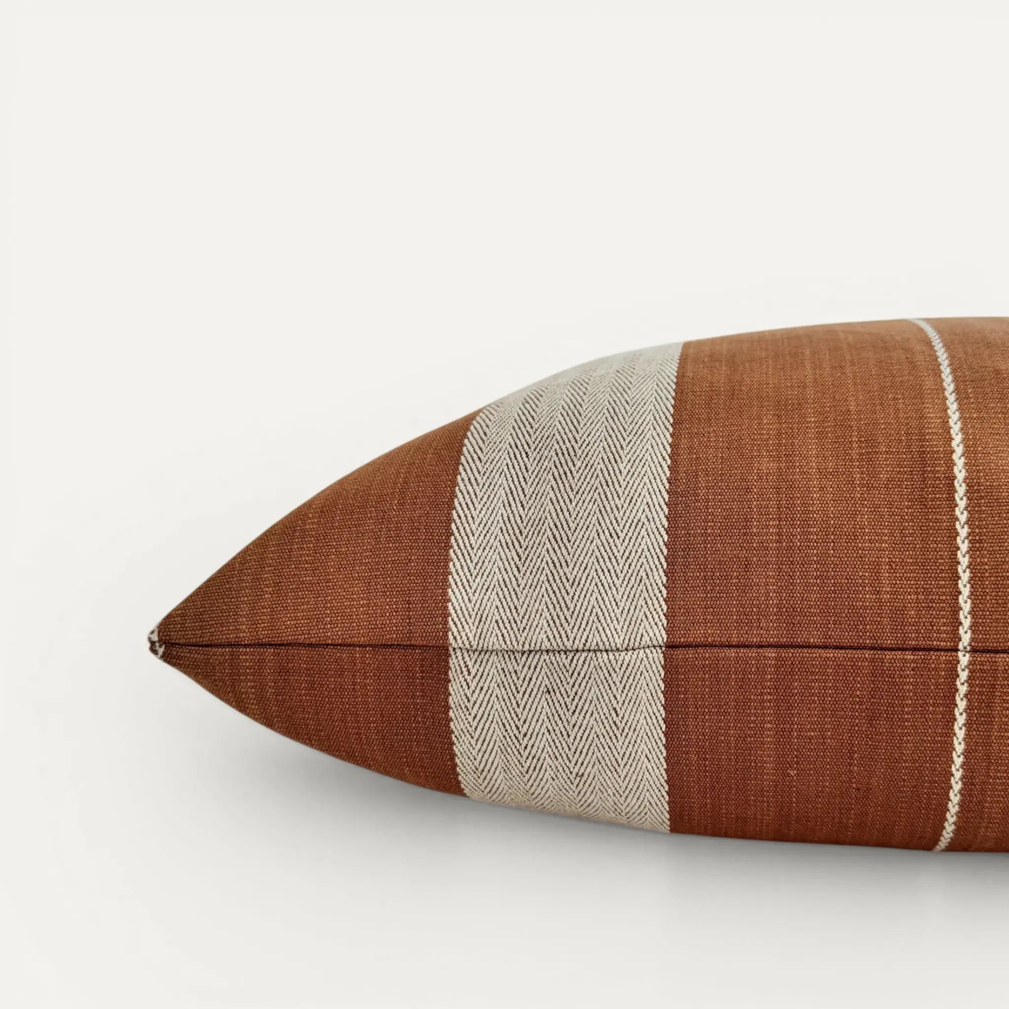 Side view of brown stripe cushion cover showing both sides of Pamir Stripe cotton fabric by GP & J Baker