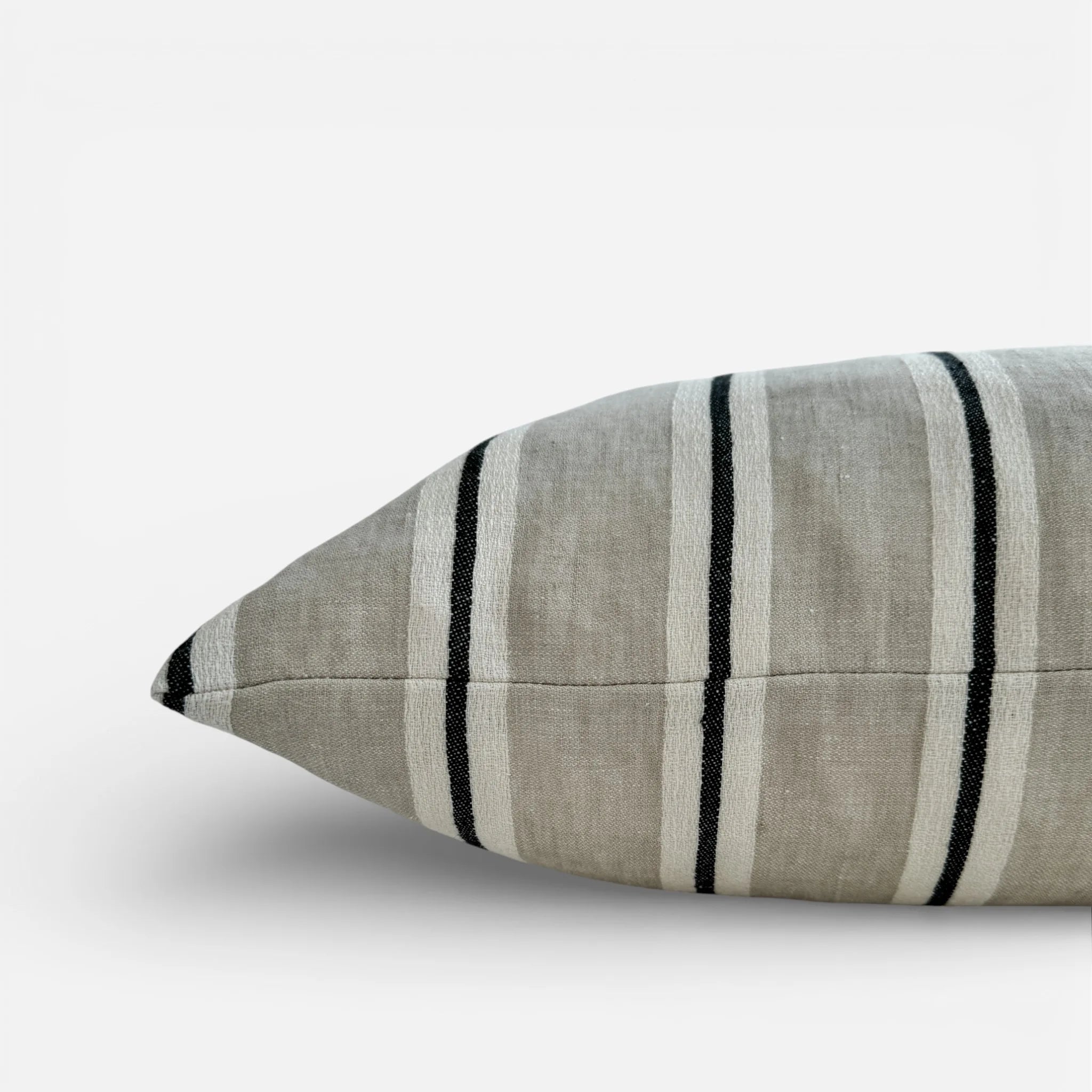Side detail view of black and white striped linen cushion cover