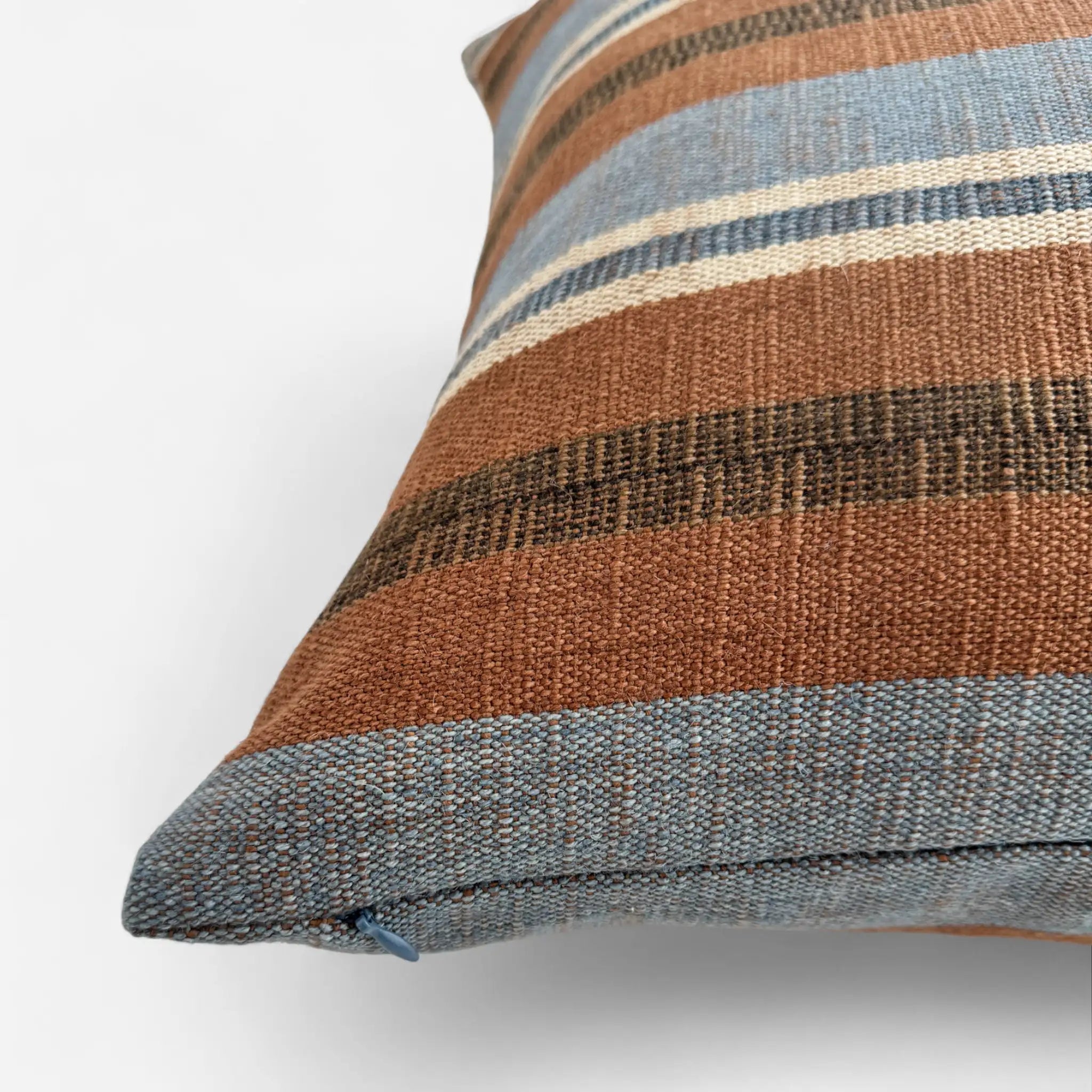 Detail view of handwoven cotton and jute cushion cover in brown and blue