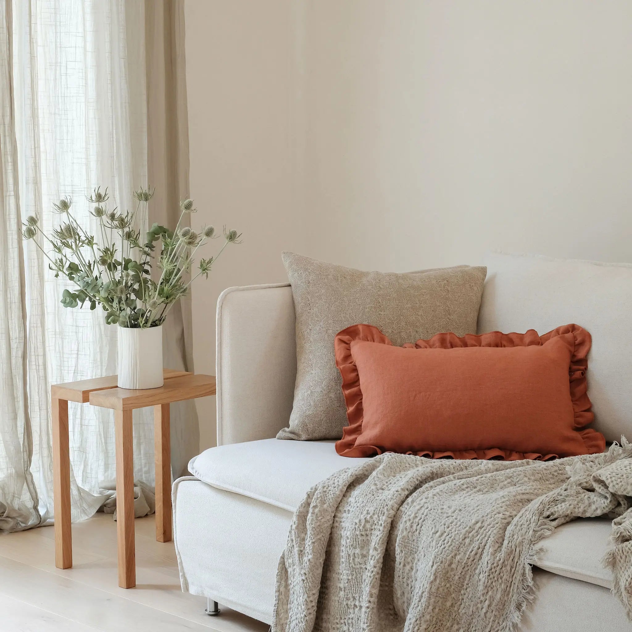 Orange frill cushion styled on white sofa