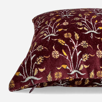 Detail view of burgundy floral velvet cushion cover