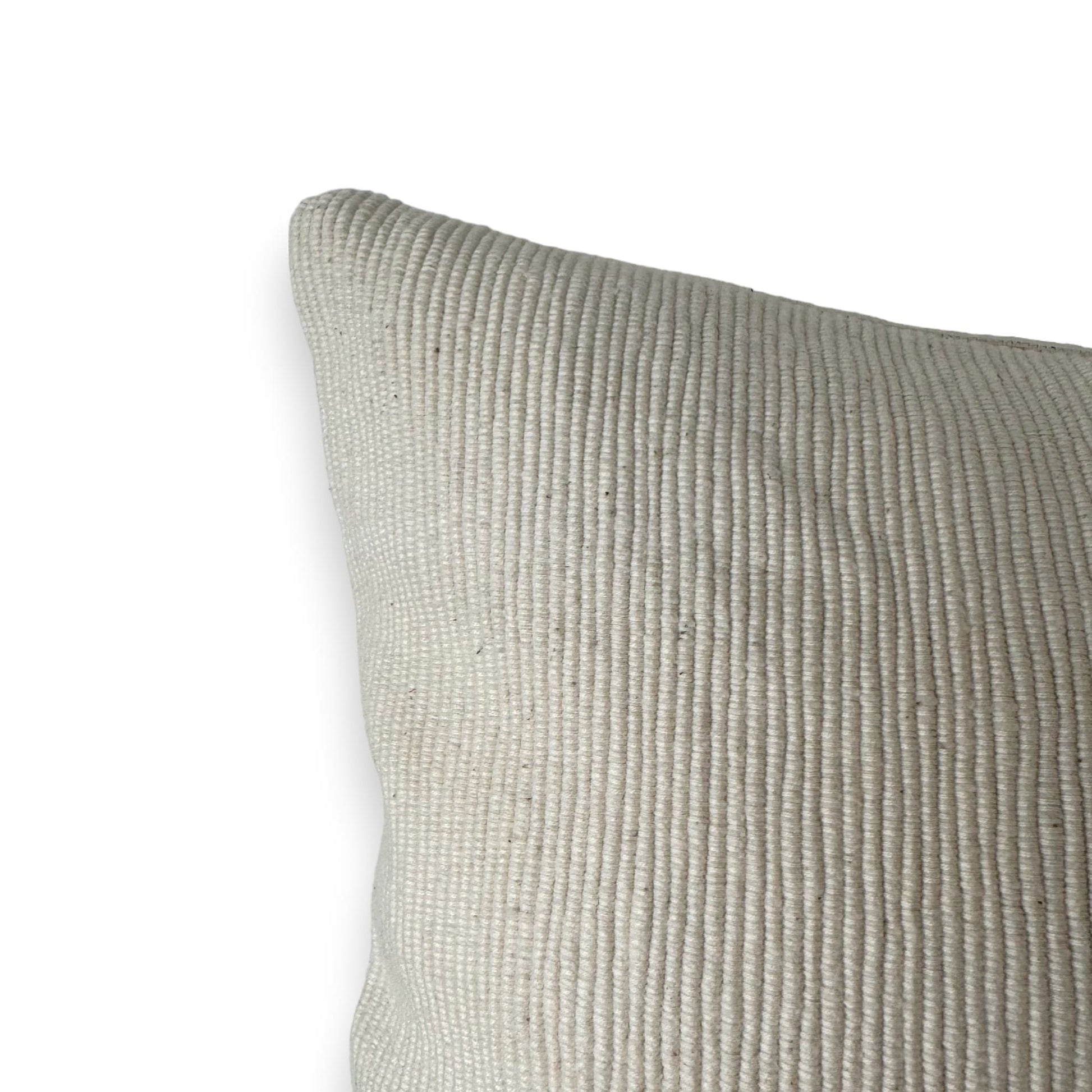 corner of white textured soft cushion cover