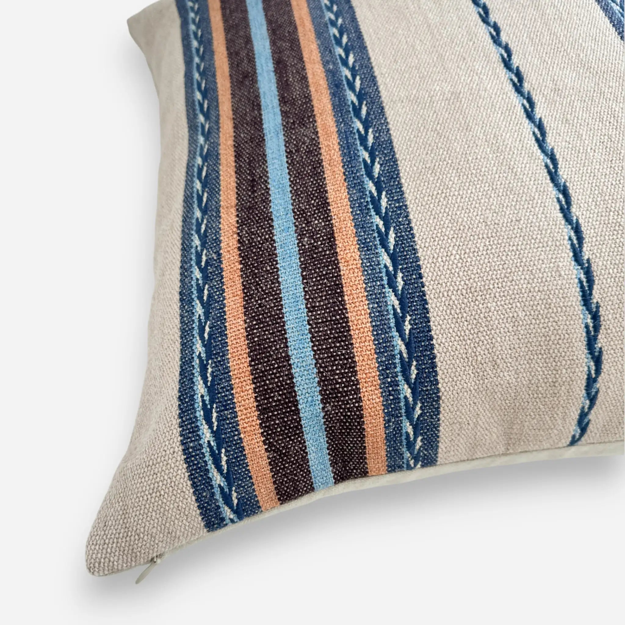 Detail view of boho striped cushion cover with blue and brown details