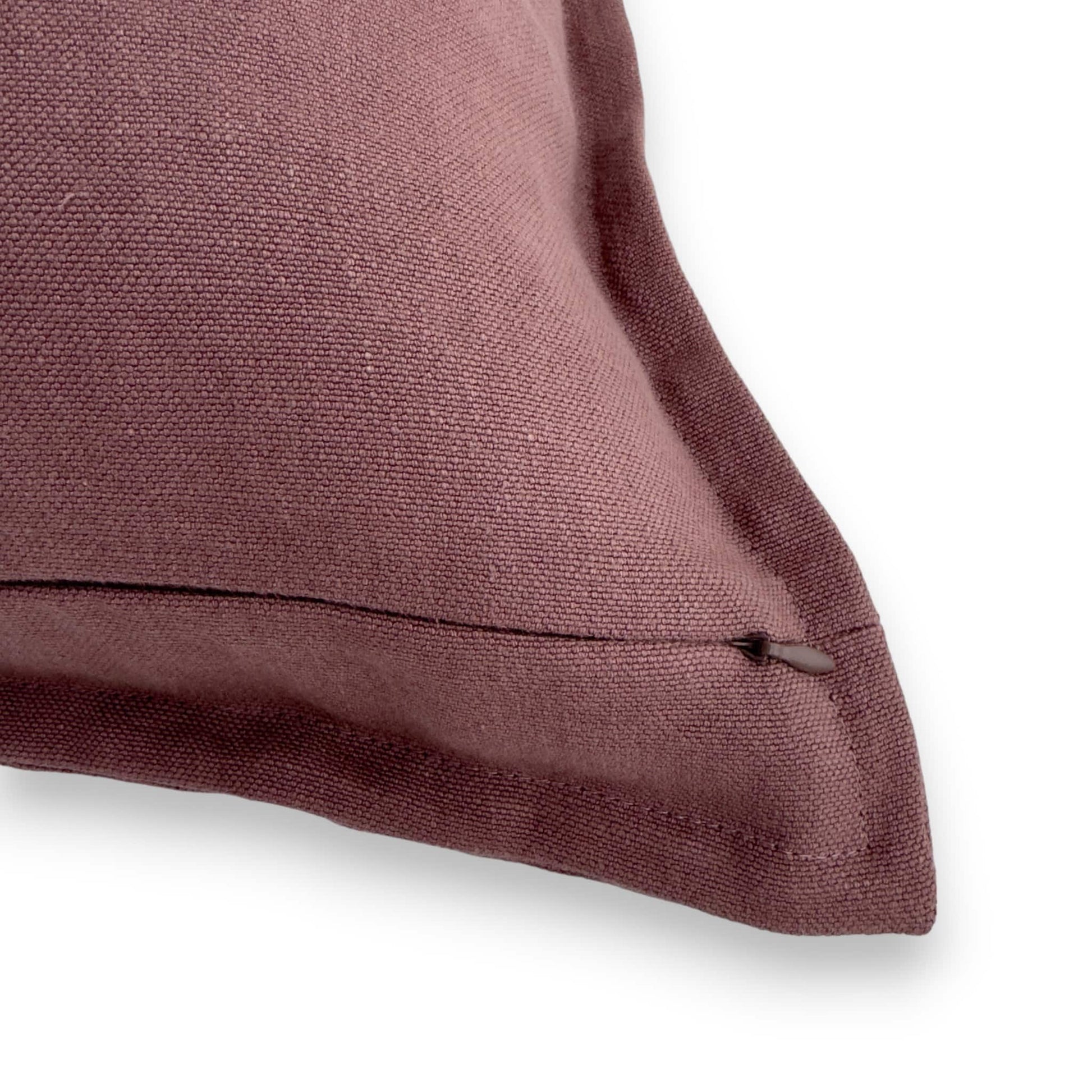 Close up view of a zipper of a purple cushion cover